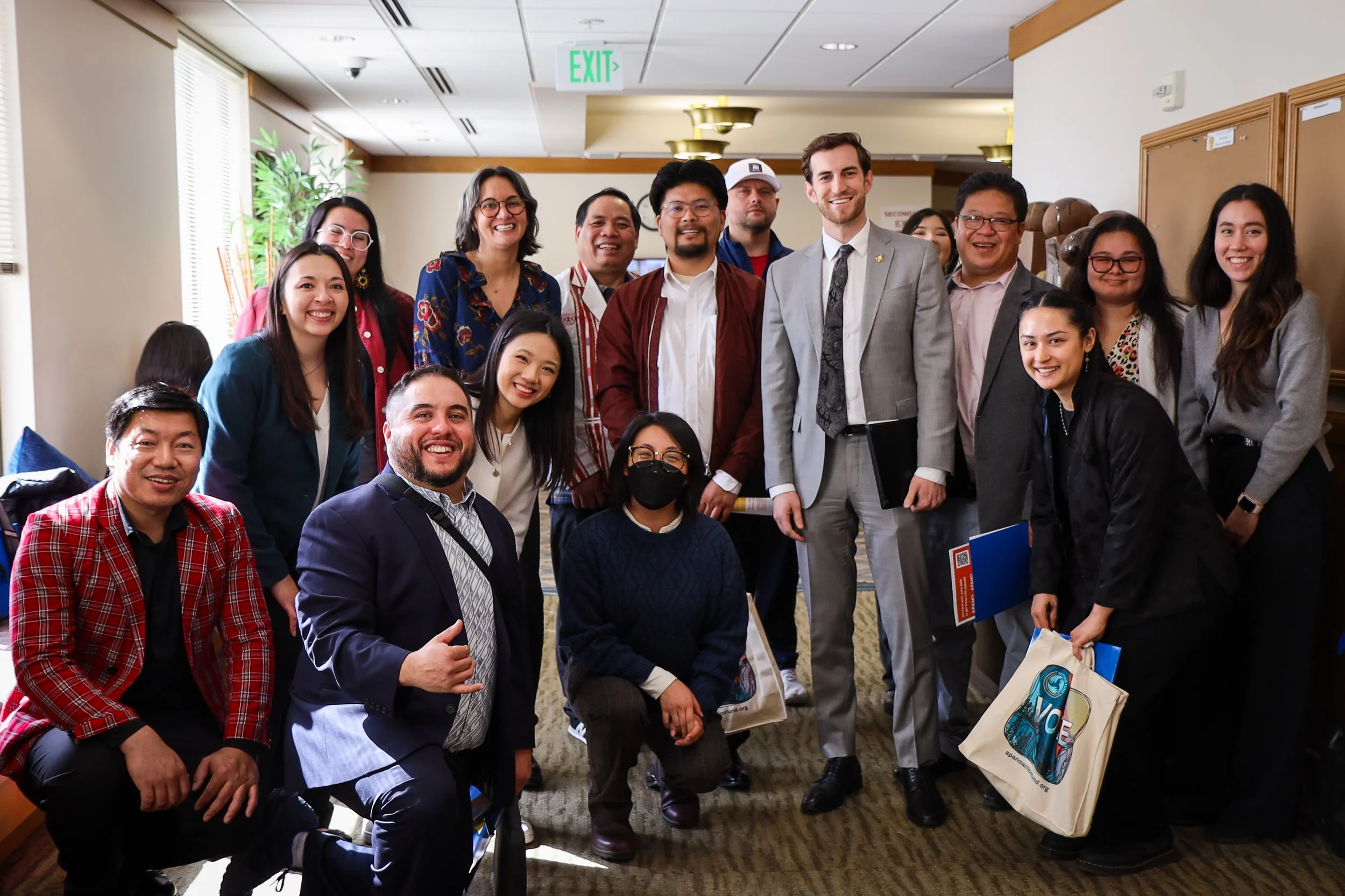 A group of APANO staff and supporters gathered indoors at the State Capitol, smiling and posing for a group photo during the 2025 Lobby Day.