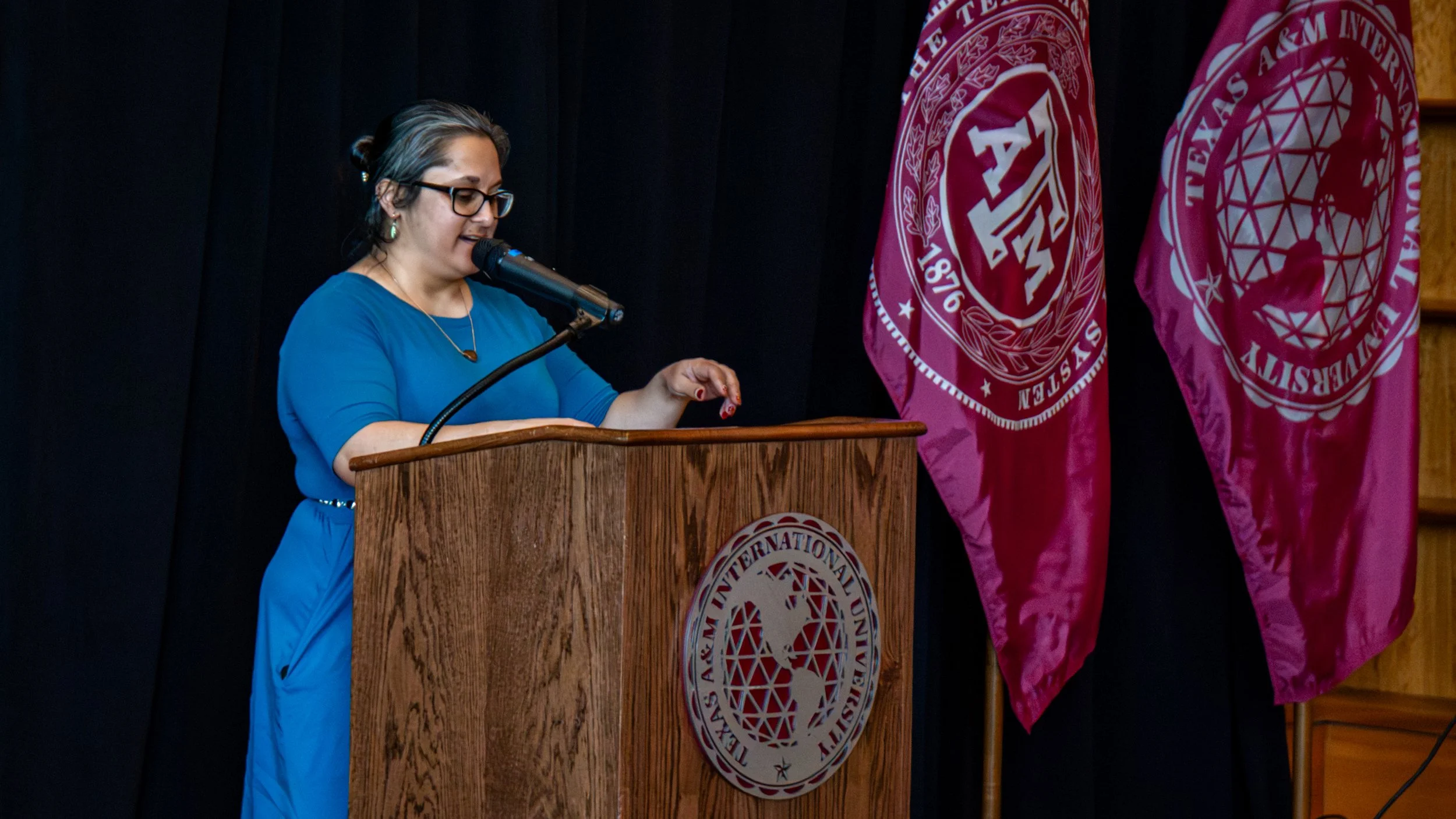 The Outreach and Assessment Librarian delivering the introduction for the featured lecture speaker of the event.