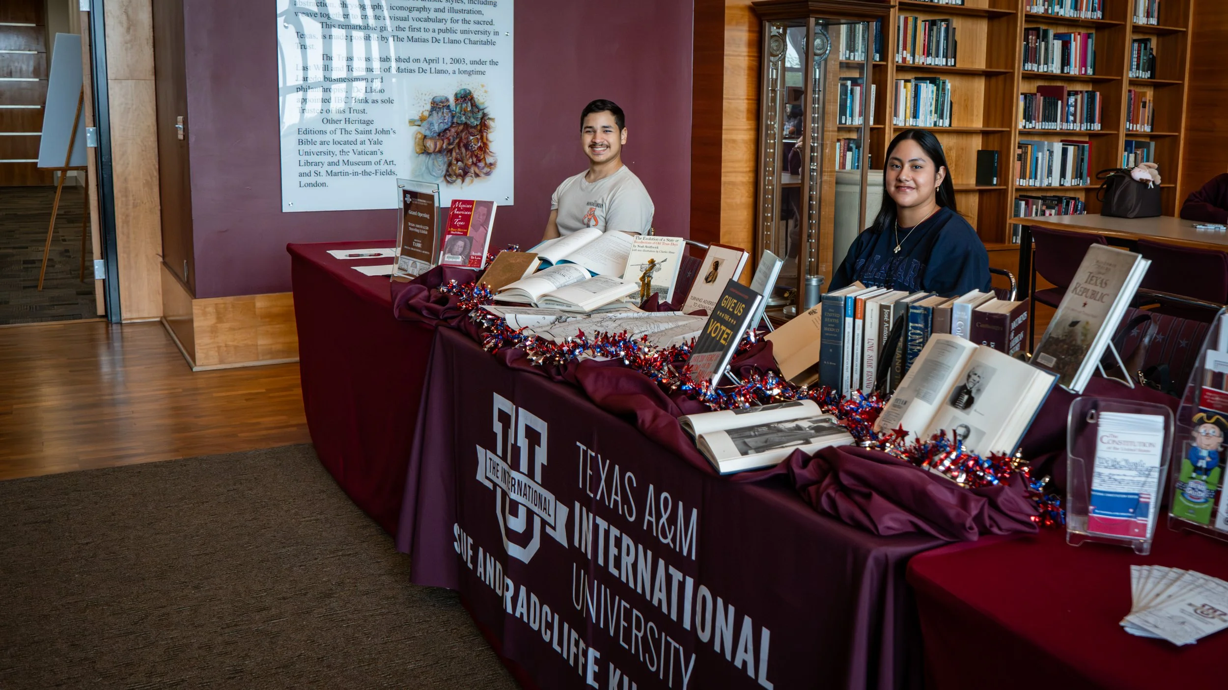 Student workers attending the exhibition table at the event.
