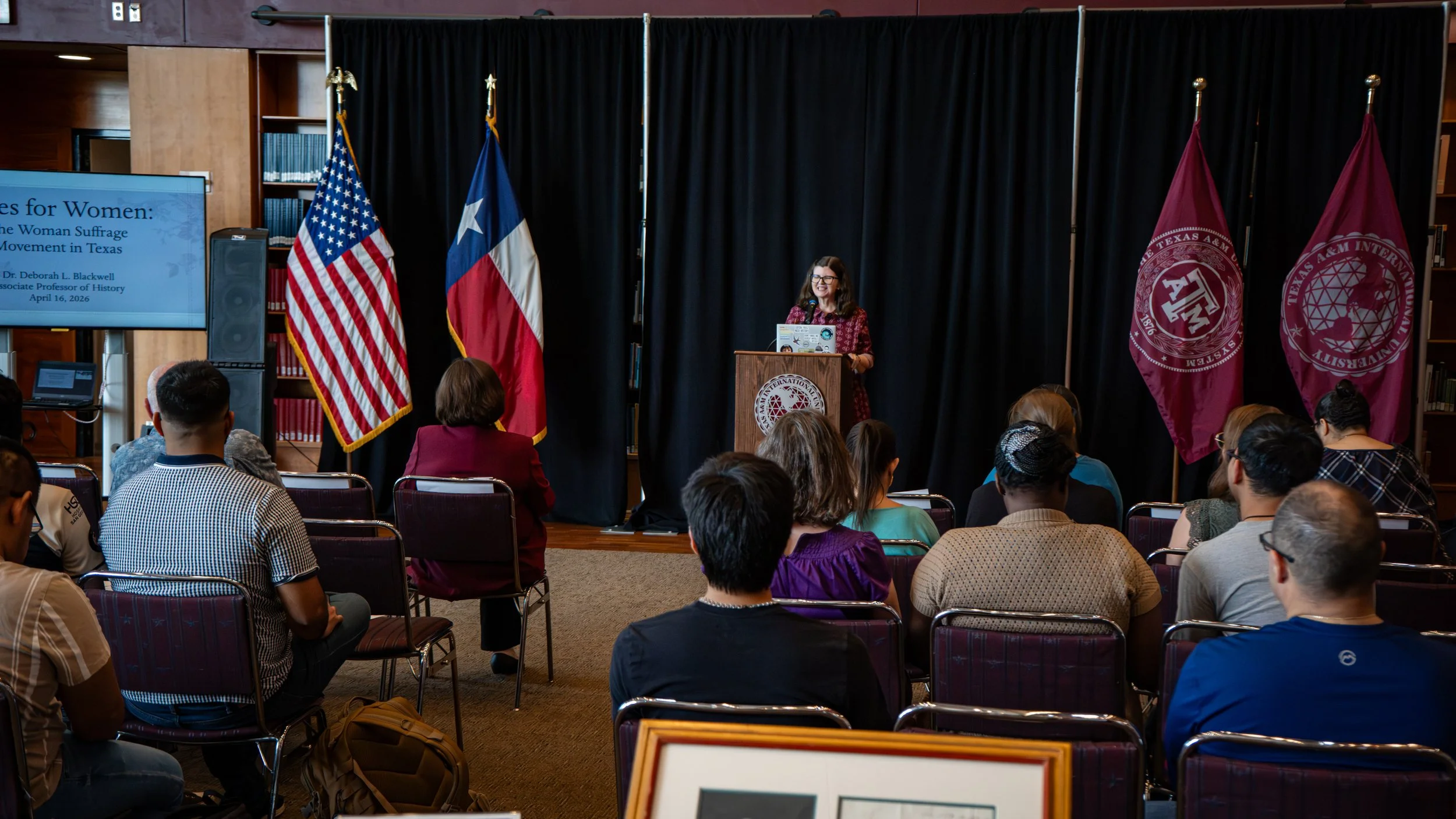 The distinguished Associate Professor of History from the Humanities Department delivering a speech on Women and the Suffrage Movement in Texas.