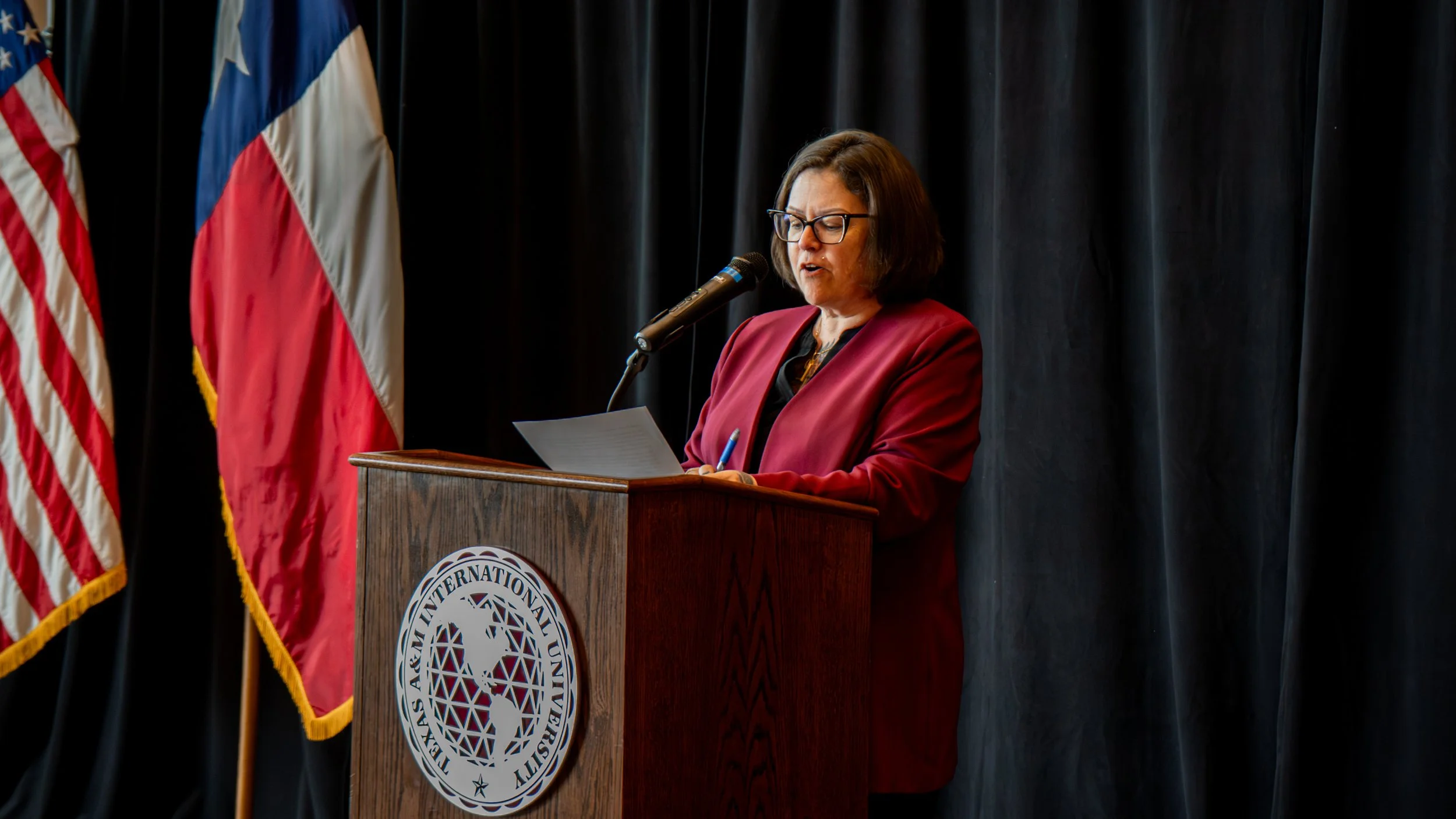 The Dean of the Library delivering the Welcome speech to the audience.