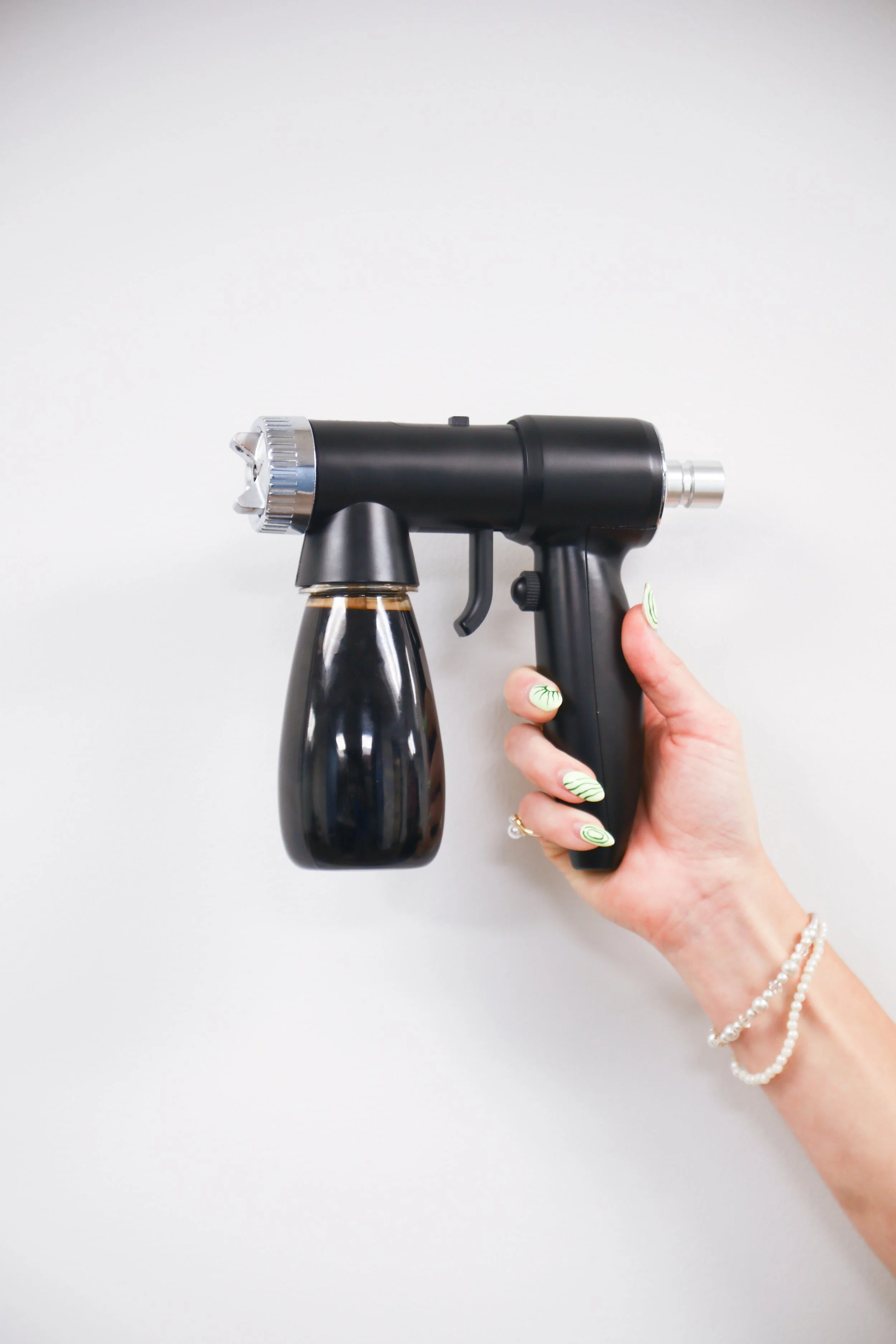 spray tan gun filled with spray tan solution