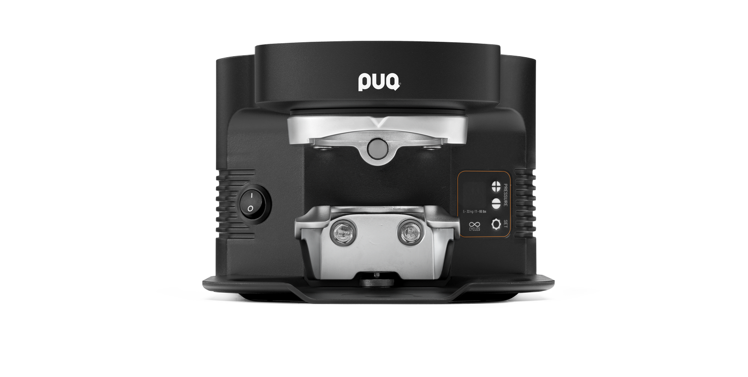 A black and silver食品 slicer with a L-shaped design, branded 'puc', featuring a power switch, pressure control, and adjustment knobs.