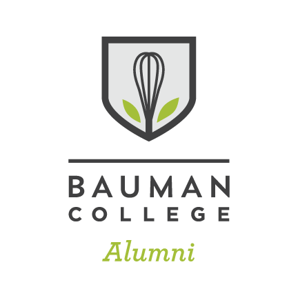 Bauman College Alumni logo featuring a shield with a whisk and green leaves.