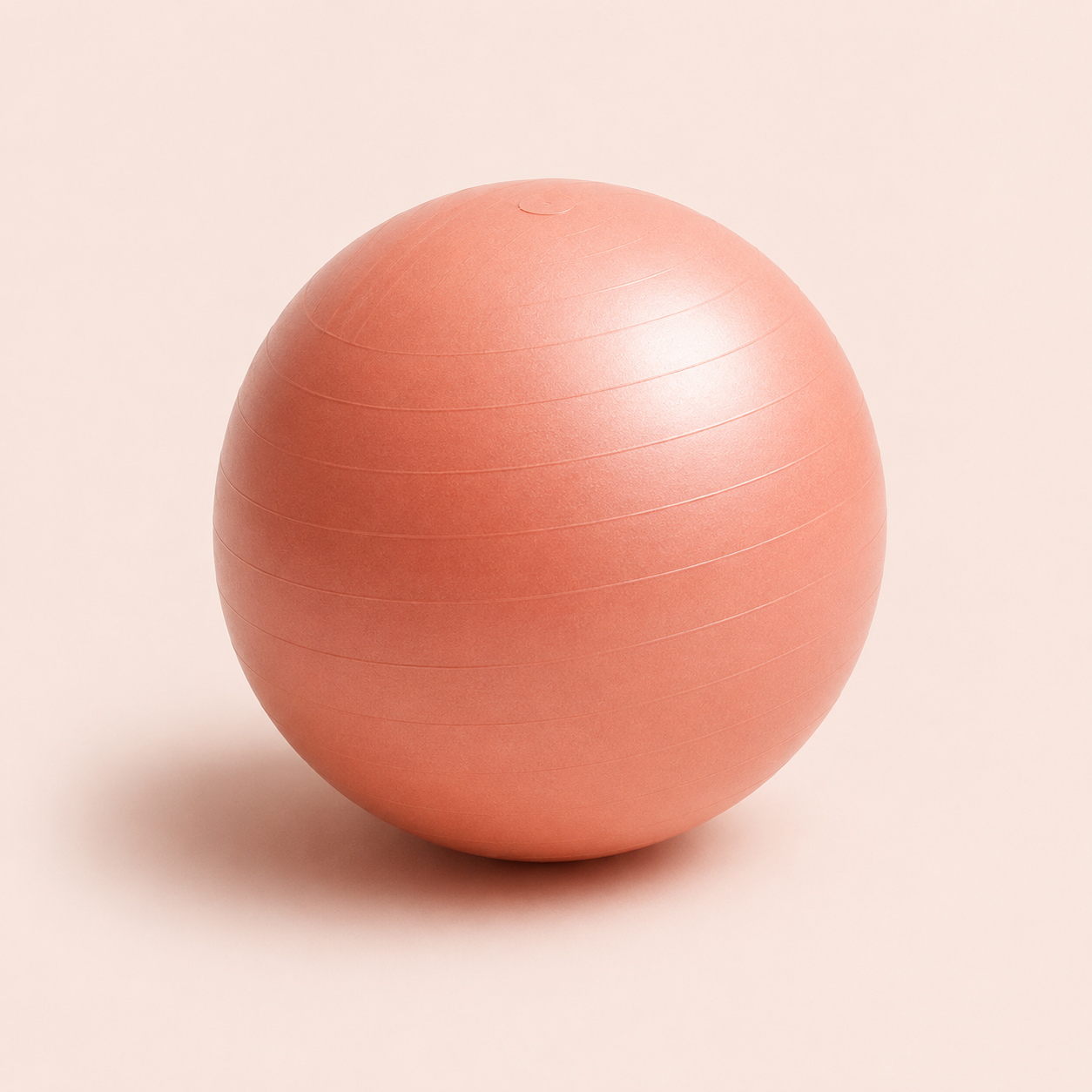 Pink exercise ball on a light background.