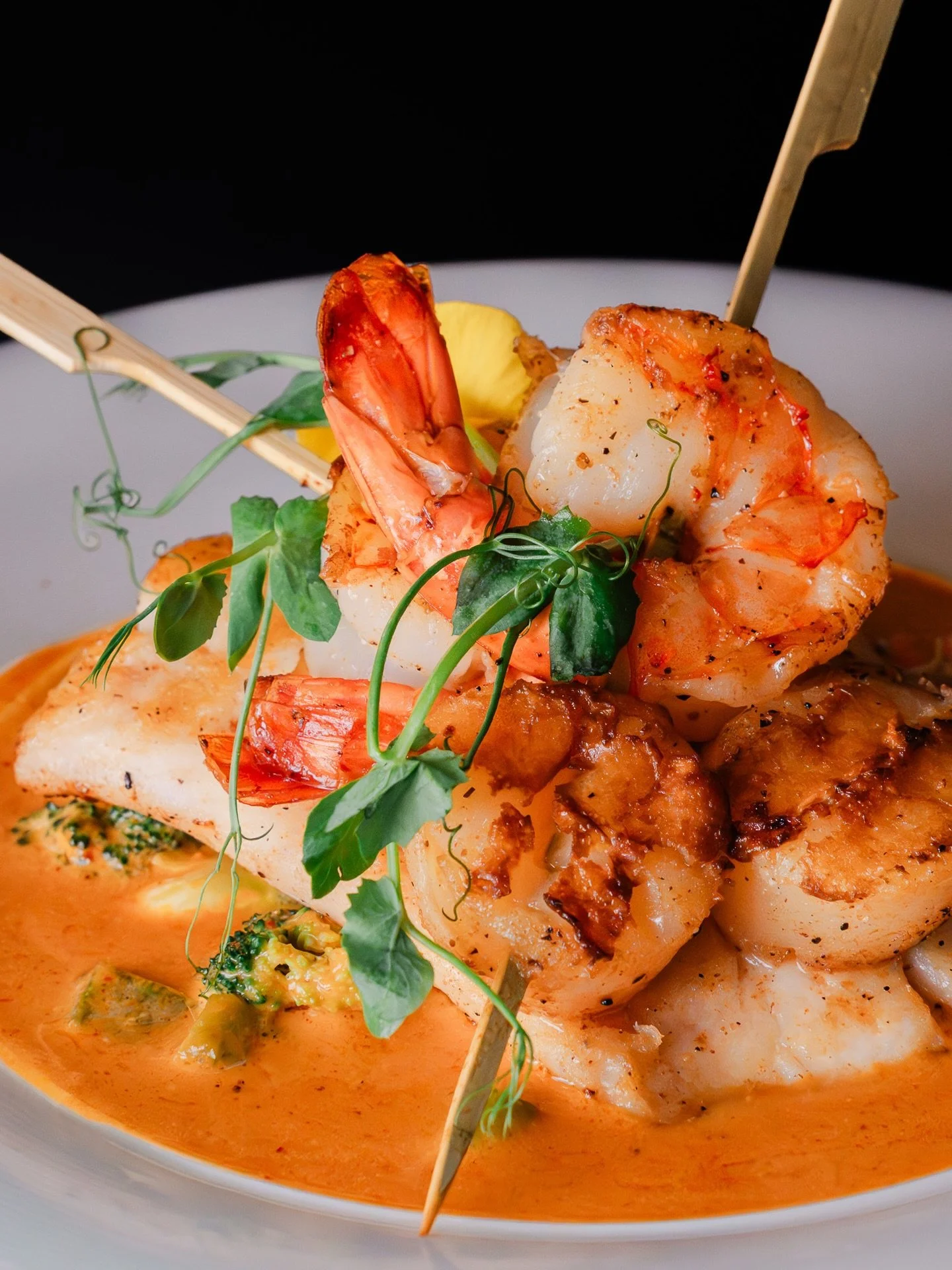 An exquisite coastal trio. Premium seared Grouper, shrimp, and scallops paired with crisp brussels sprouts and vibrant vegetables in a smooth, mildly spiced signature coconut sauce. 

Book your table through the link in our bio.