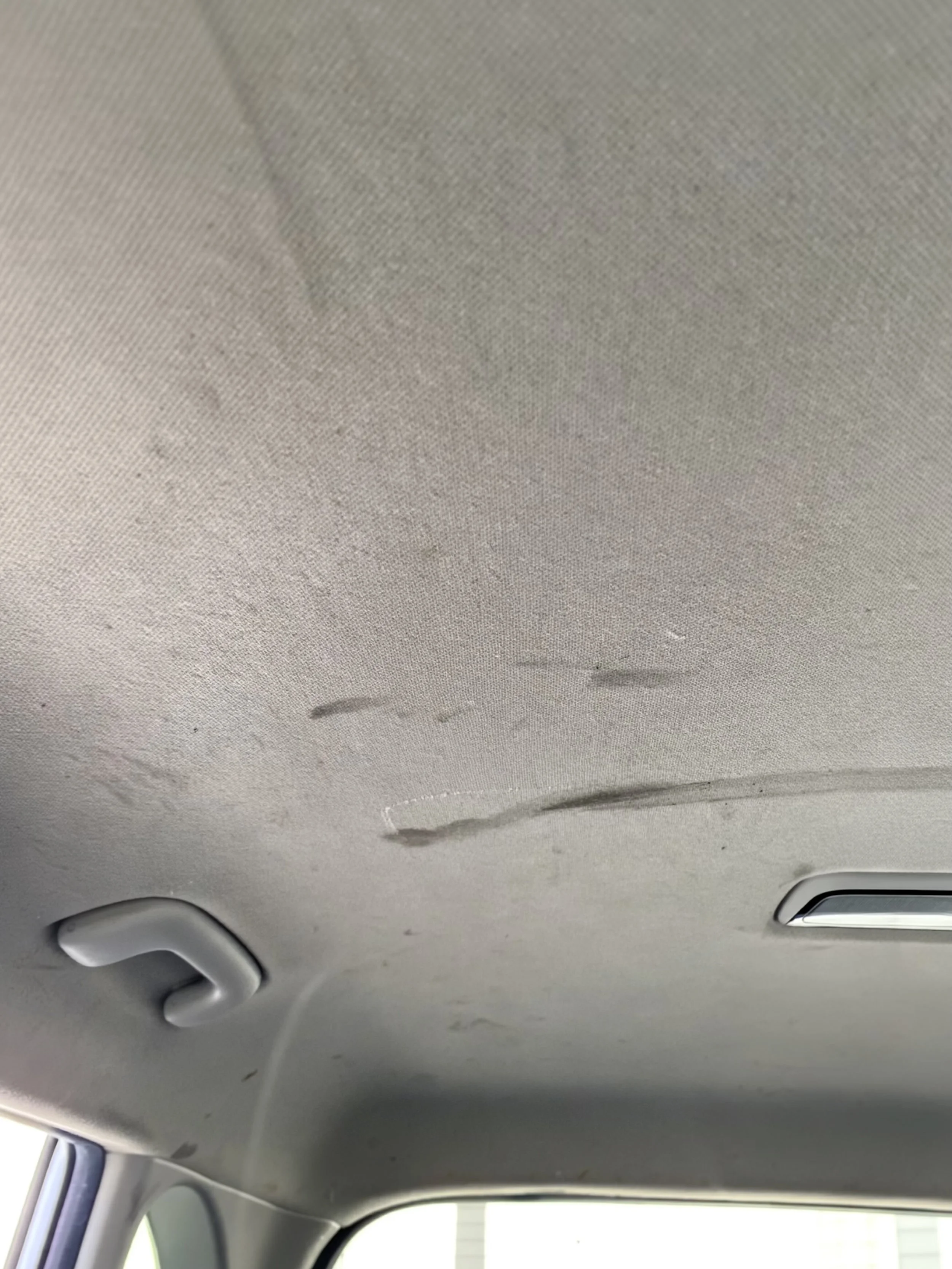 Stained vehicle headliner before a Signature Interior Detail