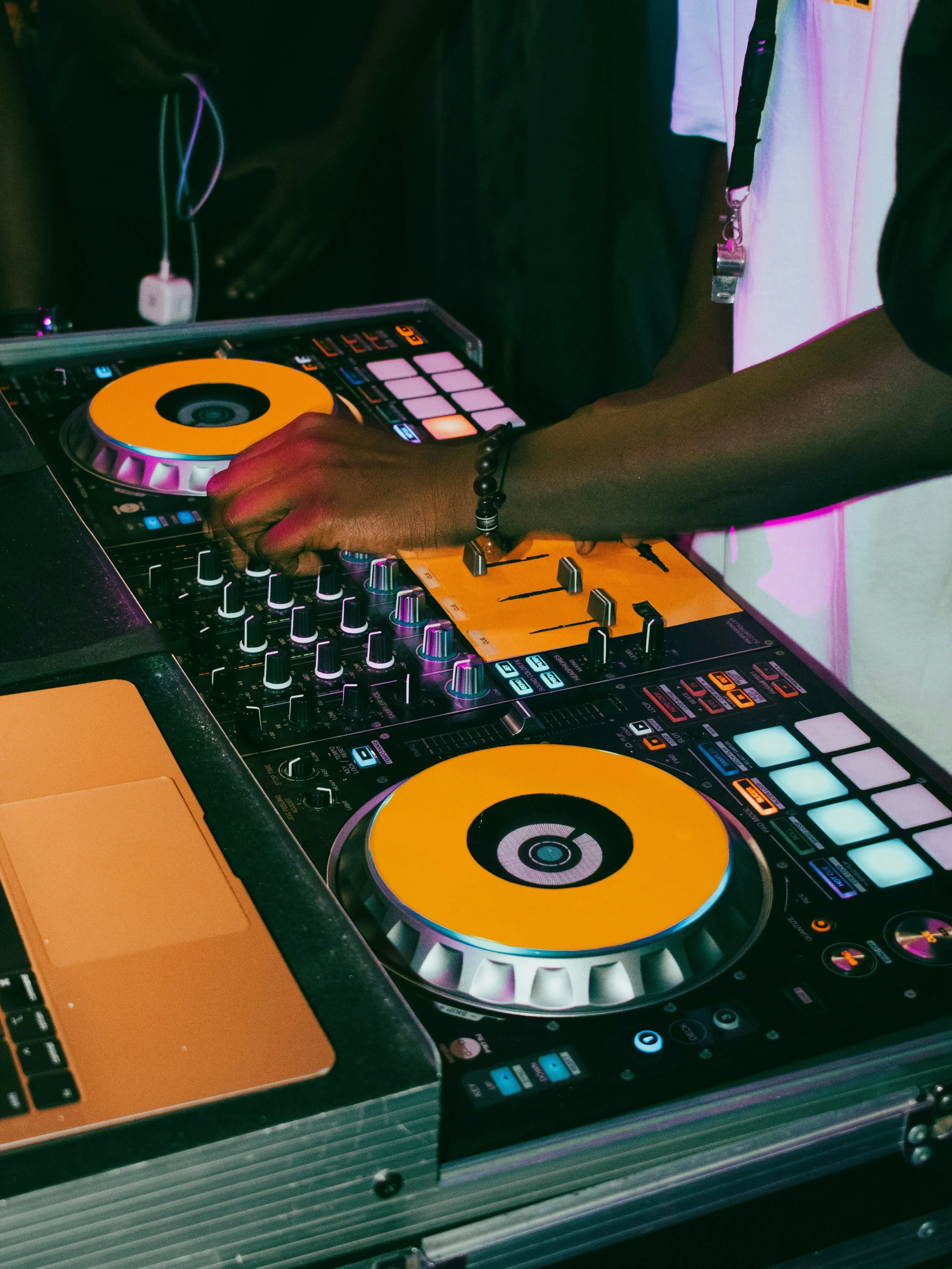 A Dj Mixing Music On A Large Mixer.