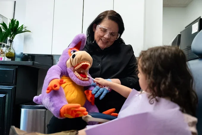 Towne Lake Family Dentistry team member helping a young patient feel comfortable