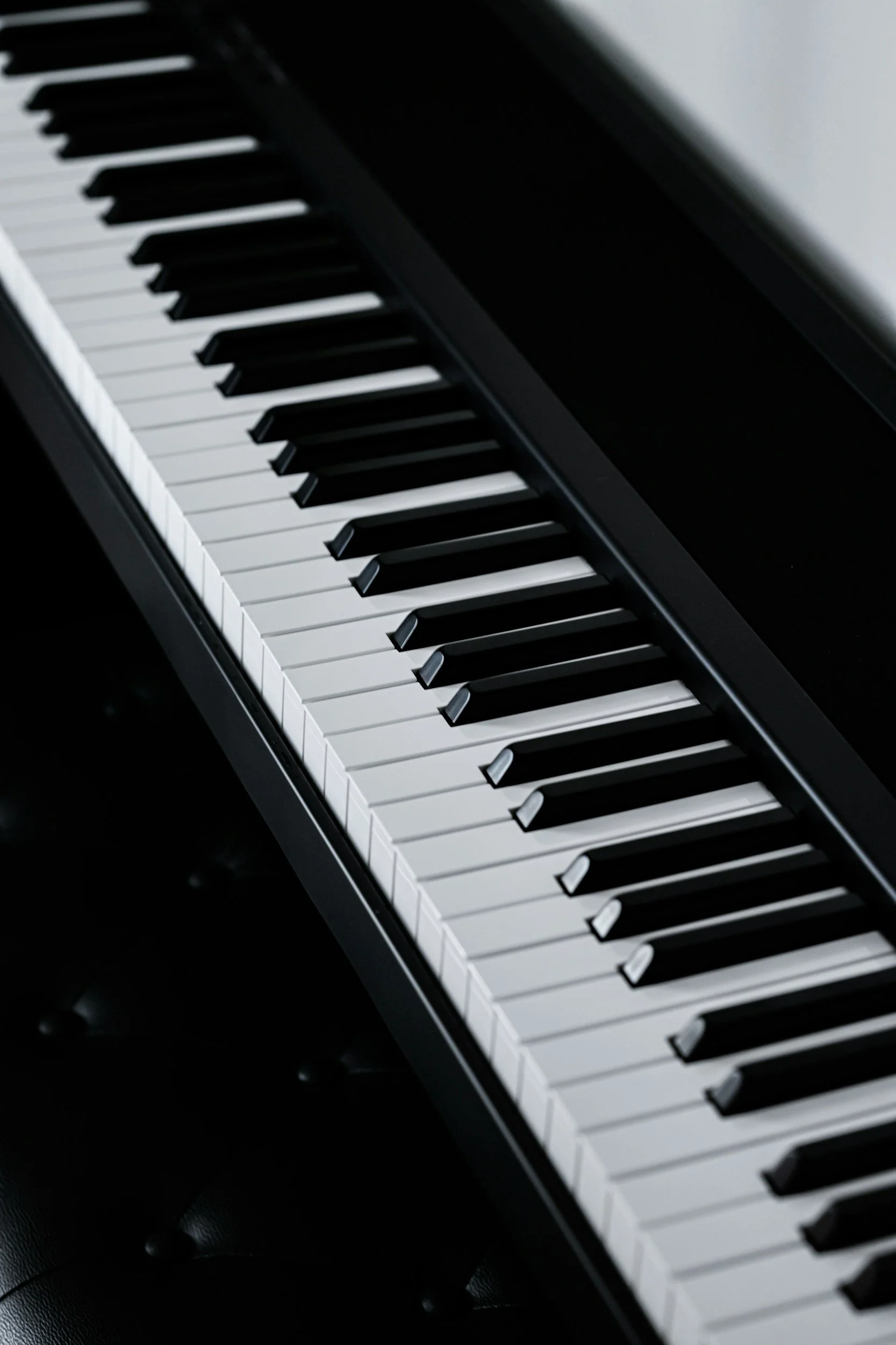 Close-up of a piano keyboard showing black and white keys.