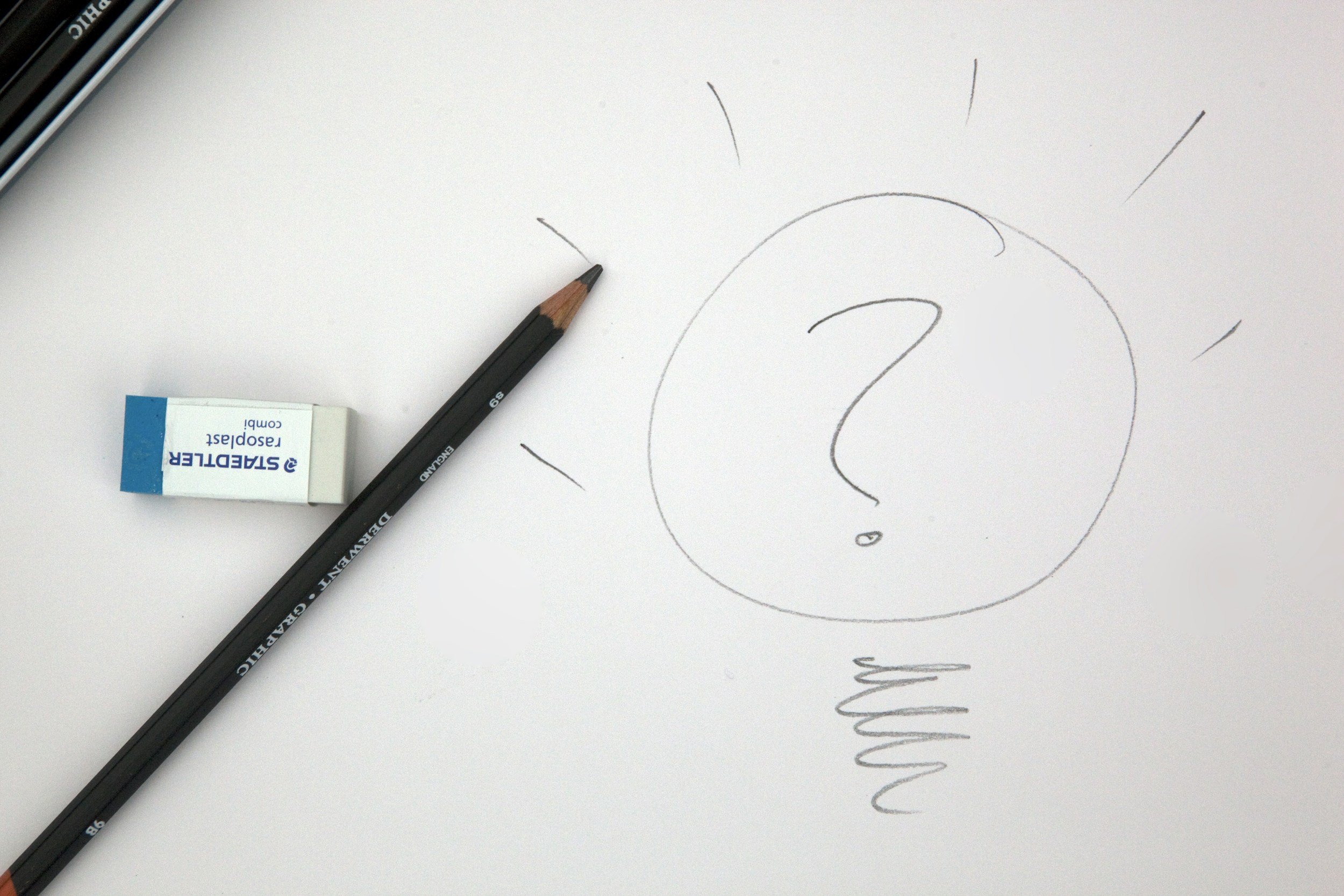 Sketch of a child's face with a circle for the head, drawn with a black pencil, placed on a white background with no other details.