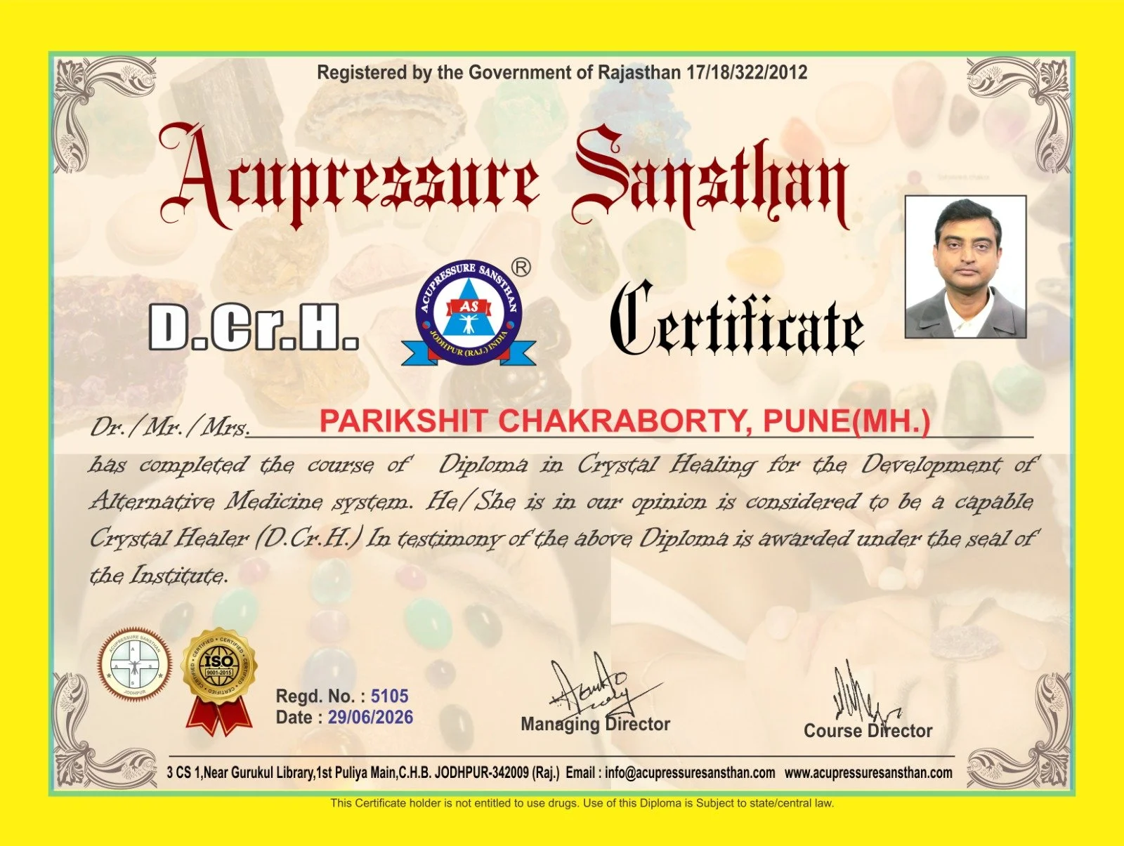 Certificate from Acupressure Sansthan awarded to Parikshit Chakraborty, Pune, for completing a diploma in crystal healing. Contains official logos, signatures, and a photograph of the recipient.