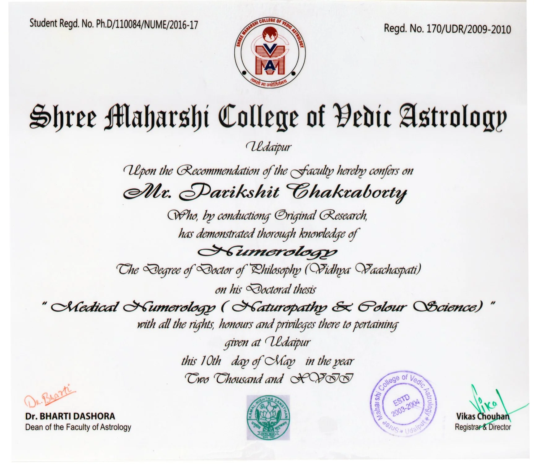 A diploma from Shree Maharshi College of Vedic Astrology awarded to Mr. Parikshit Chakraborty for a thesis in medical numerology, dated May 10th, 2011, with various official stamps and signatures.