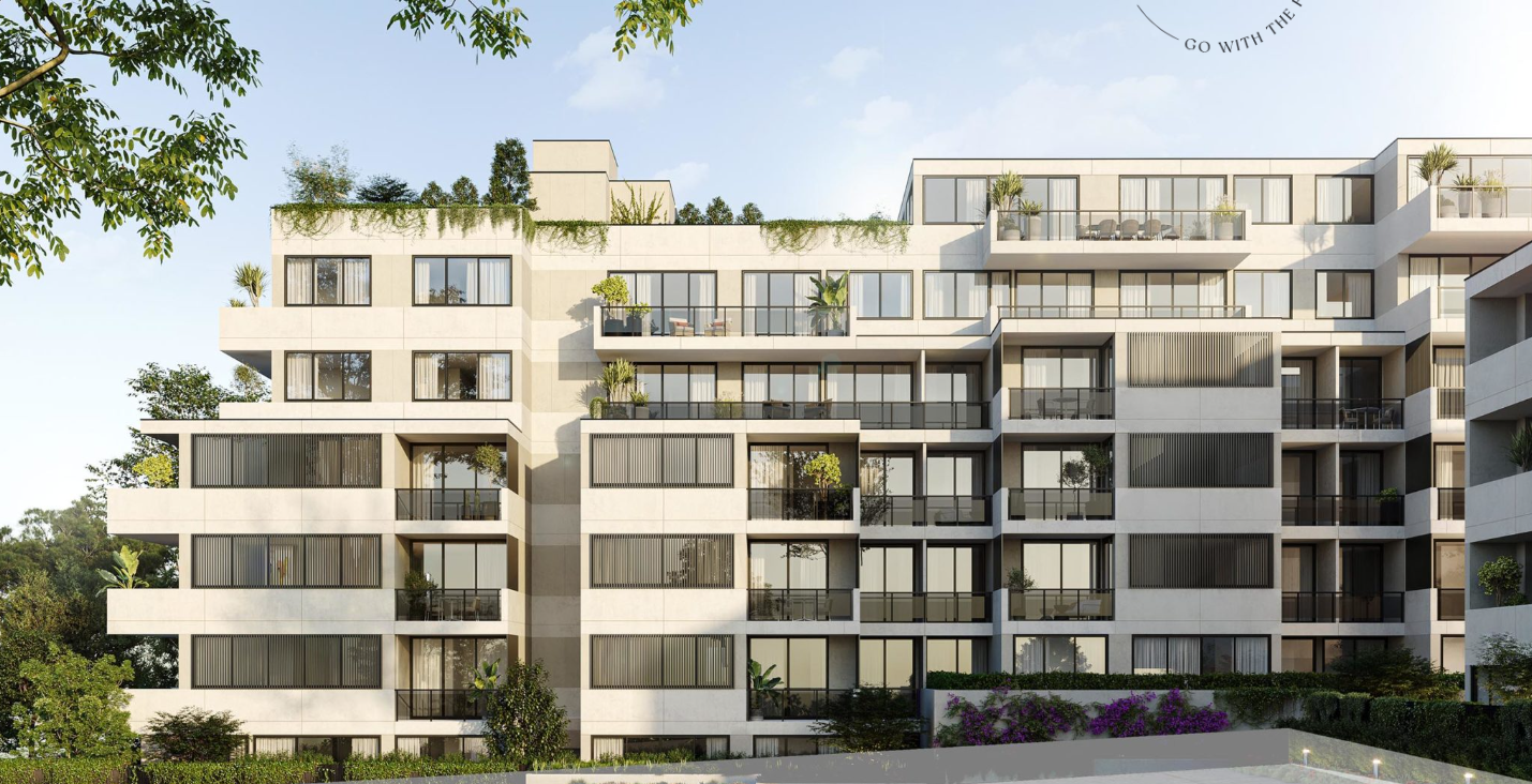 Modern multi-story apartment building with large glass windows and balconies, some with plants, surrounded by trees and greenery.