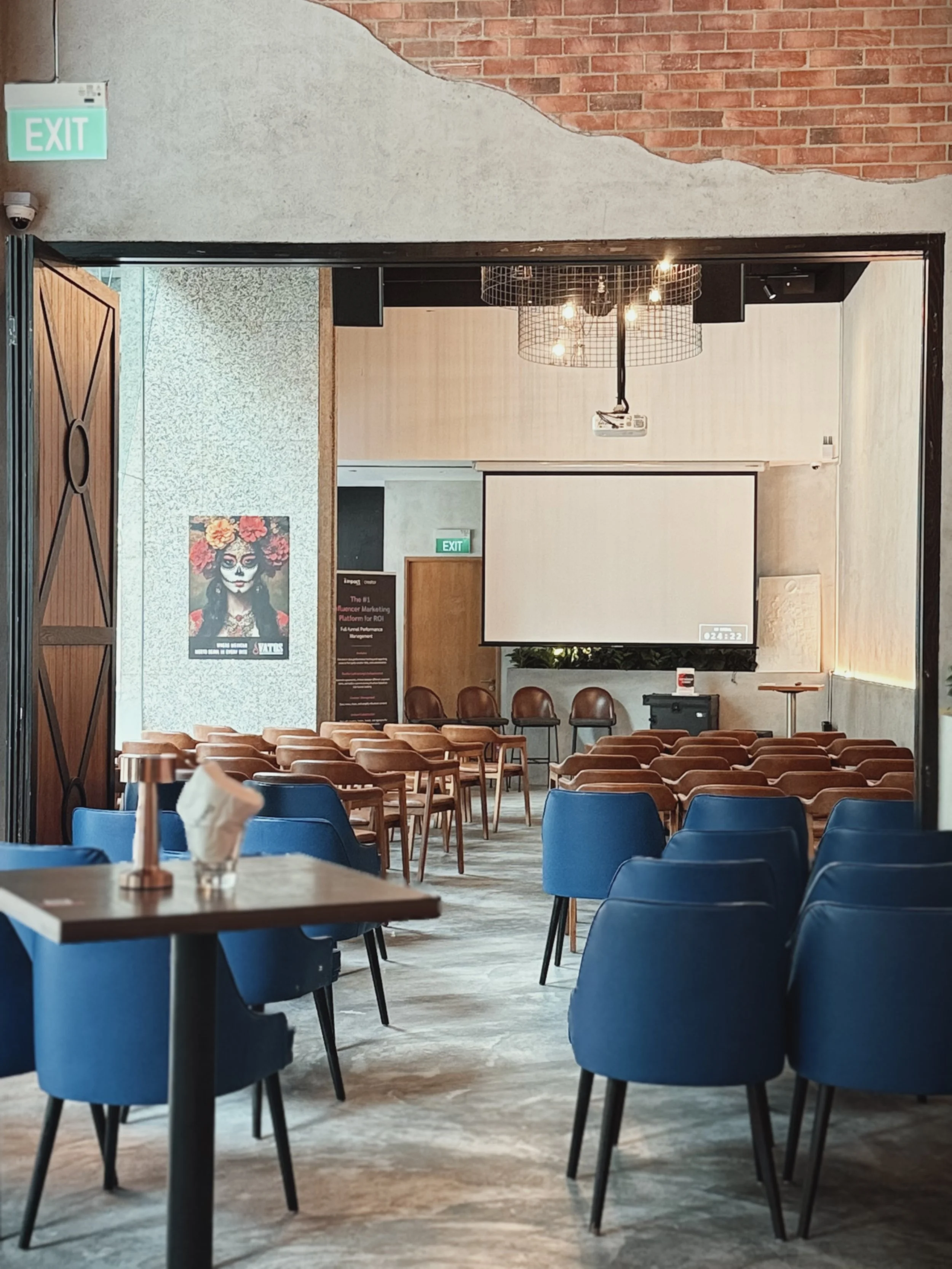 Vatos private event space set up in theatre-style seating with a projector screen for corporate events
