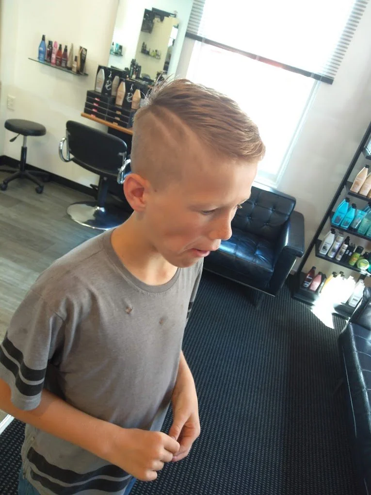 Young boy with a buzz cut hairstyle by Randall at Carlton Hair Corp's Christchurch Kids Hair Salon