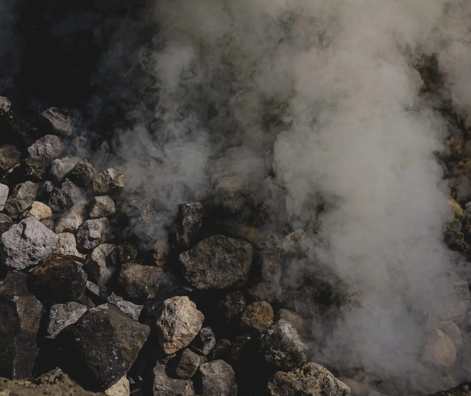 Vapor rising from hot rocks in the process of making oaxaca mezcal