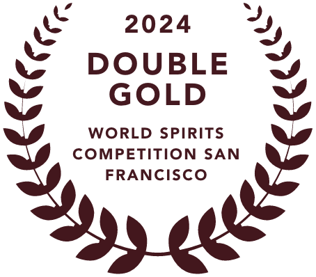 Emblem with laurel wreath surrounding text that reads '2024 Double Gold World Spirits Competition San Francisco' awarded to mala mía mezcal, positioning it among the best mezcal brands.