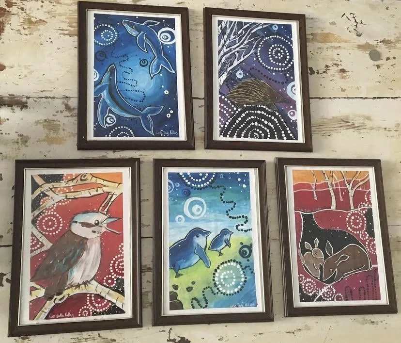 Five framed paintings depicting Australian animals and nature scenes. Whales, Echidna, Kookaburra, Fairy Penguins and Bilbies.