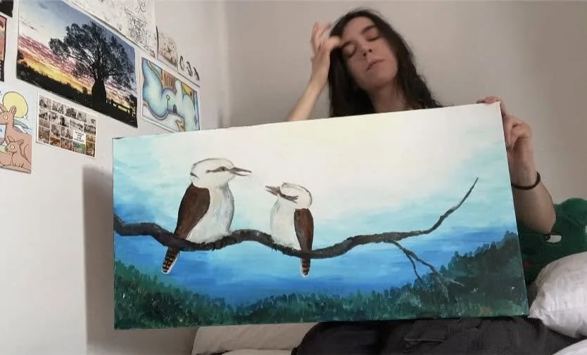 Coda Ridley holding her artwork "Kookaburra and Baby in the Blue Mountains"