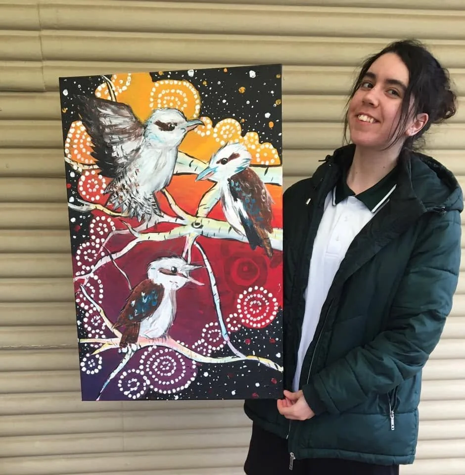 Coda Ridley holding her artwork