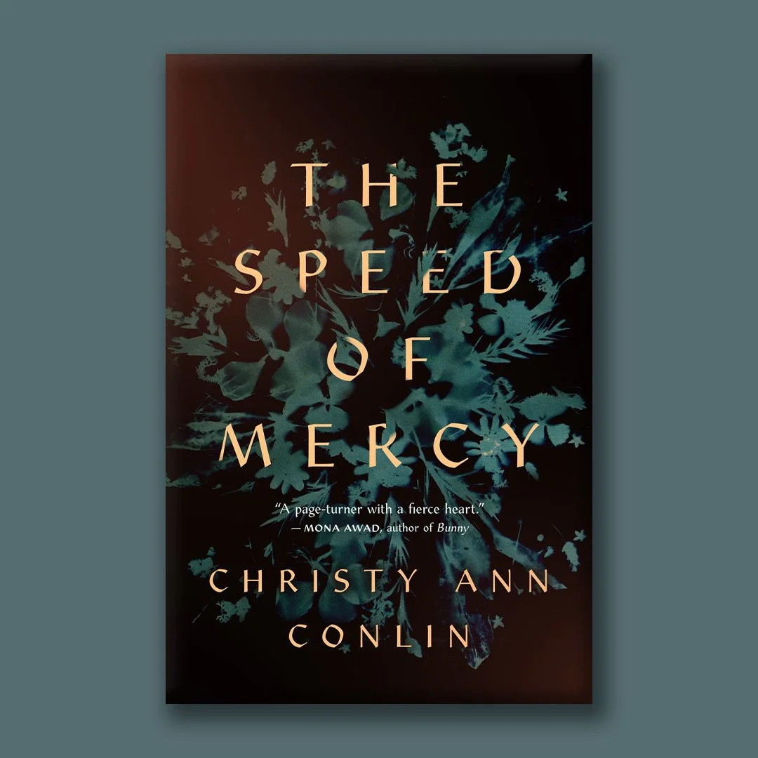 Book cover of 'The Speed of Mercy' by Christy Ann Conlin, featuring a dark background with blue floral patterns and beige text.