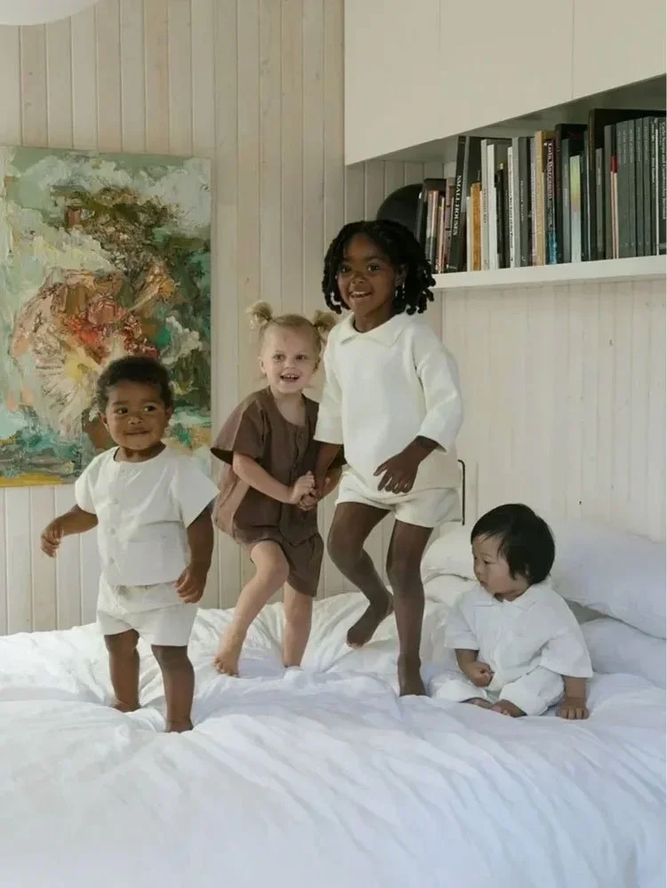 Children jumping on a bed, a campaign image for Little Eyes picture books.