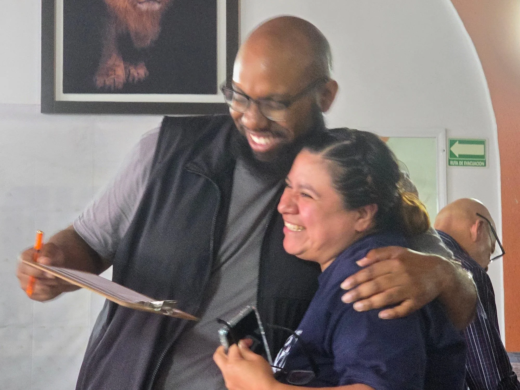 Volunteer celebrating with a community member during an Operation Serve International outreach event.