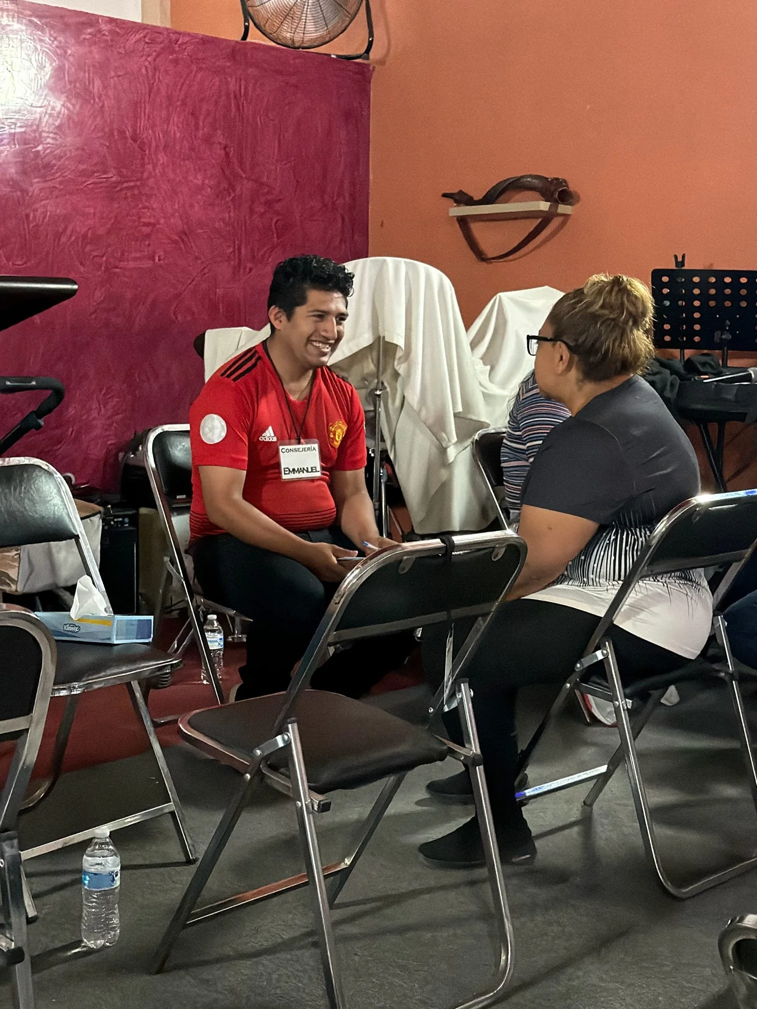 Volunteer offering encouragement and conversation during a ministry counseling session.