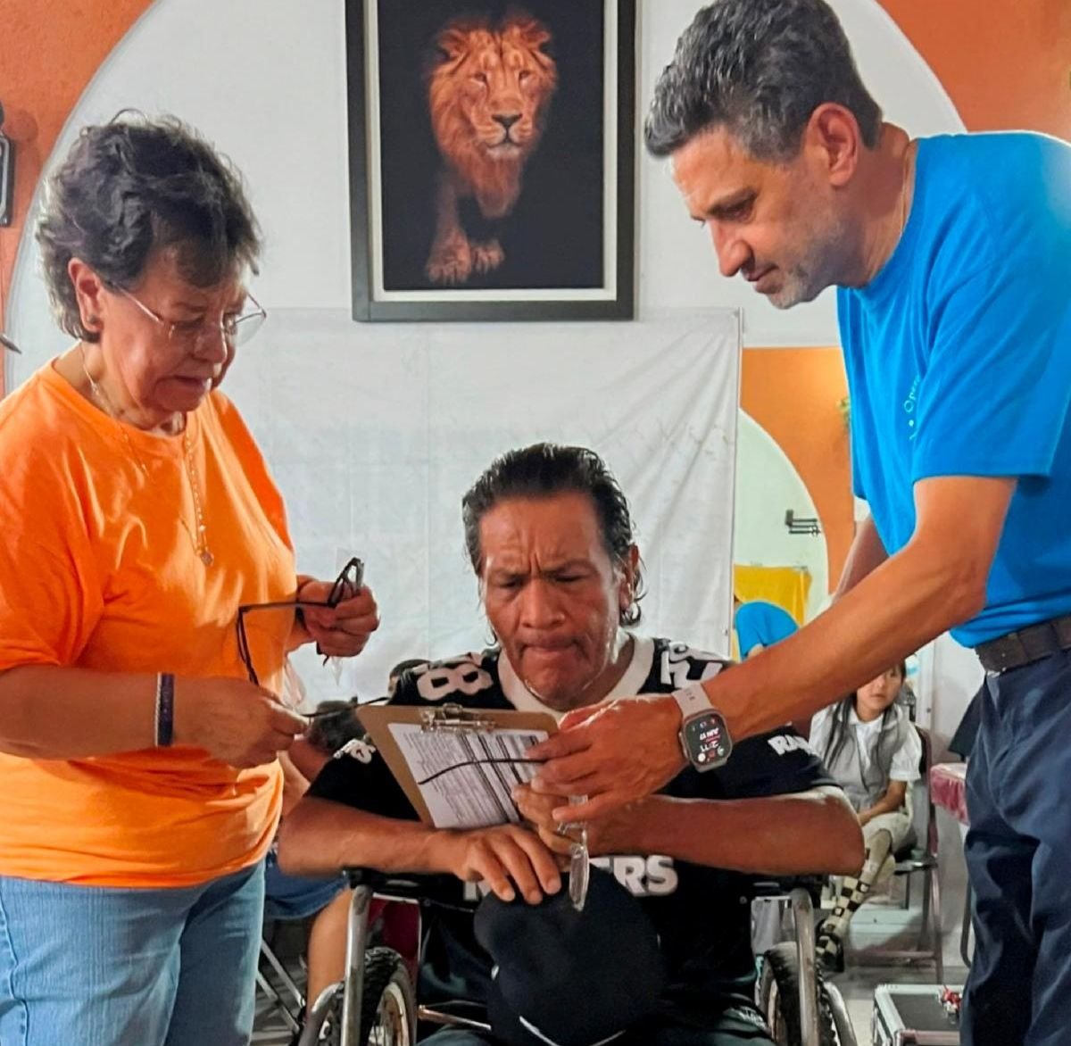 OSI leaders assist a man with his medical paperwork