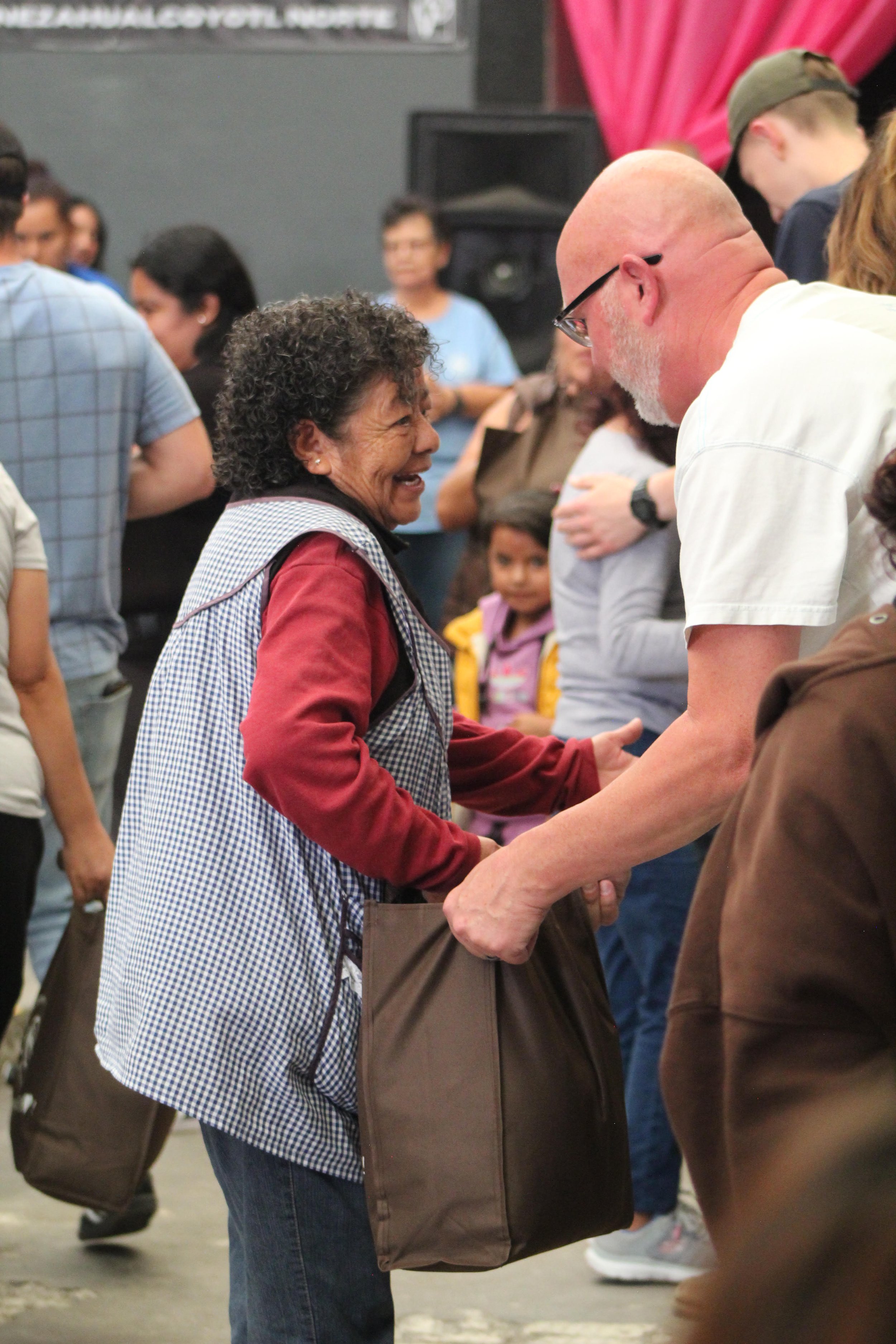 Community member receiving encouragement and donations during an Operation Serve International outreach.