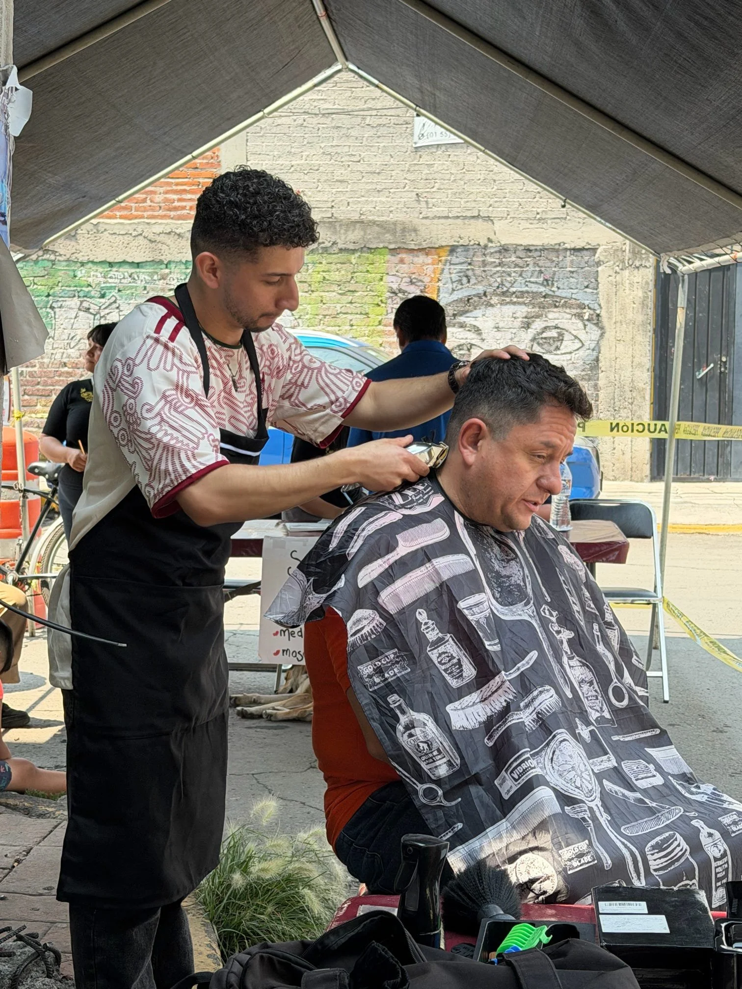 Volunteer providing a free haircut during an Operation Serve International community outreach.
