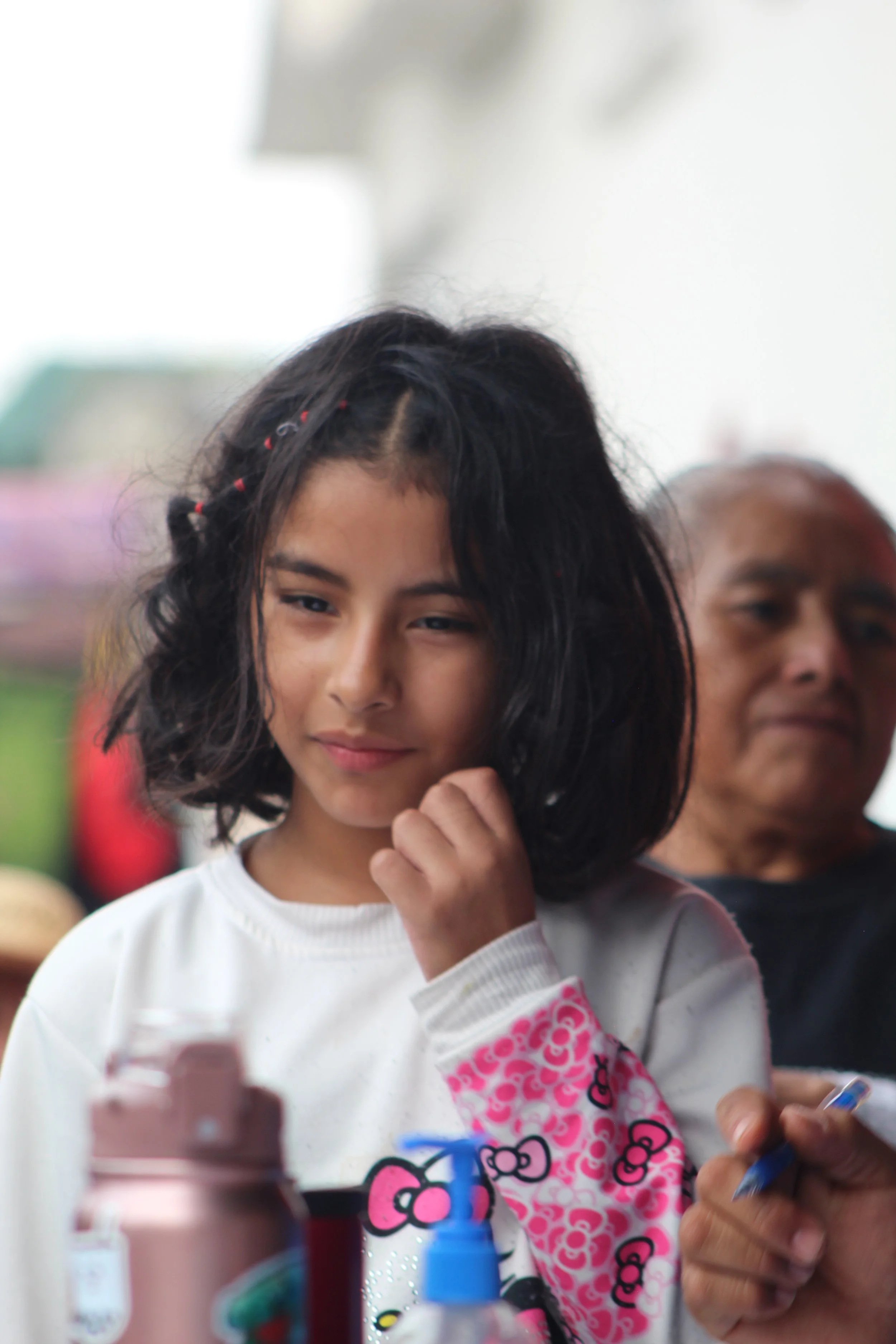 Young girl participating in a children's outreach activity during an Operation Serve International event.