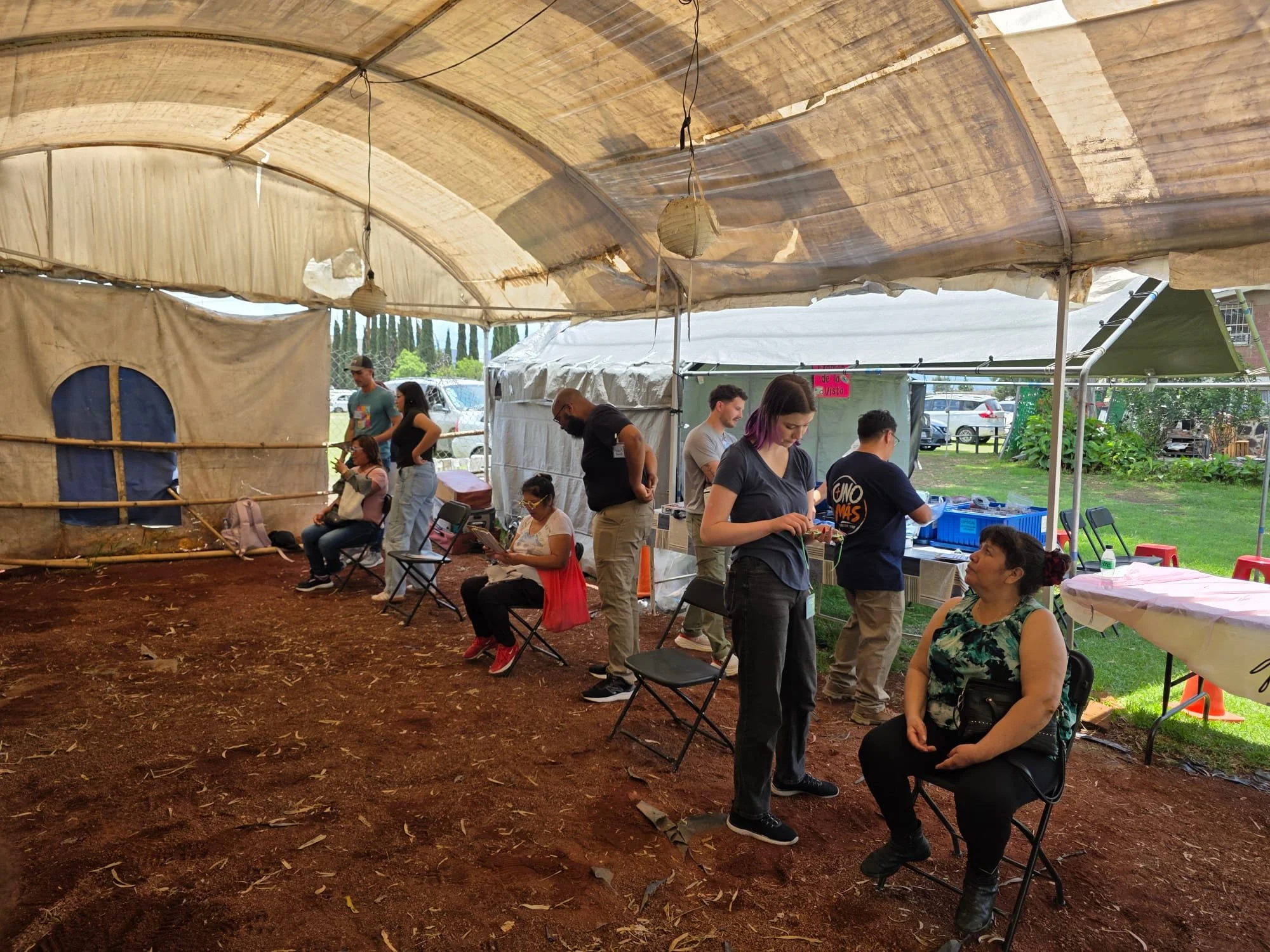 Operation Serve International volunteers serving community members outdoors at a medical outreach clinic.