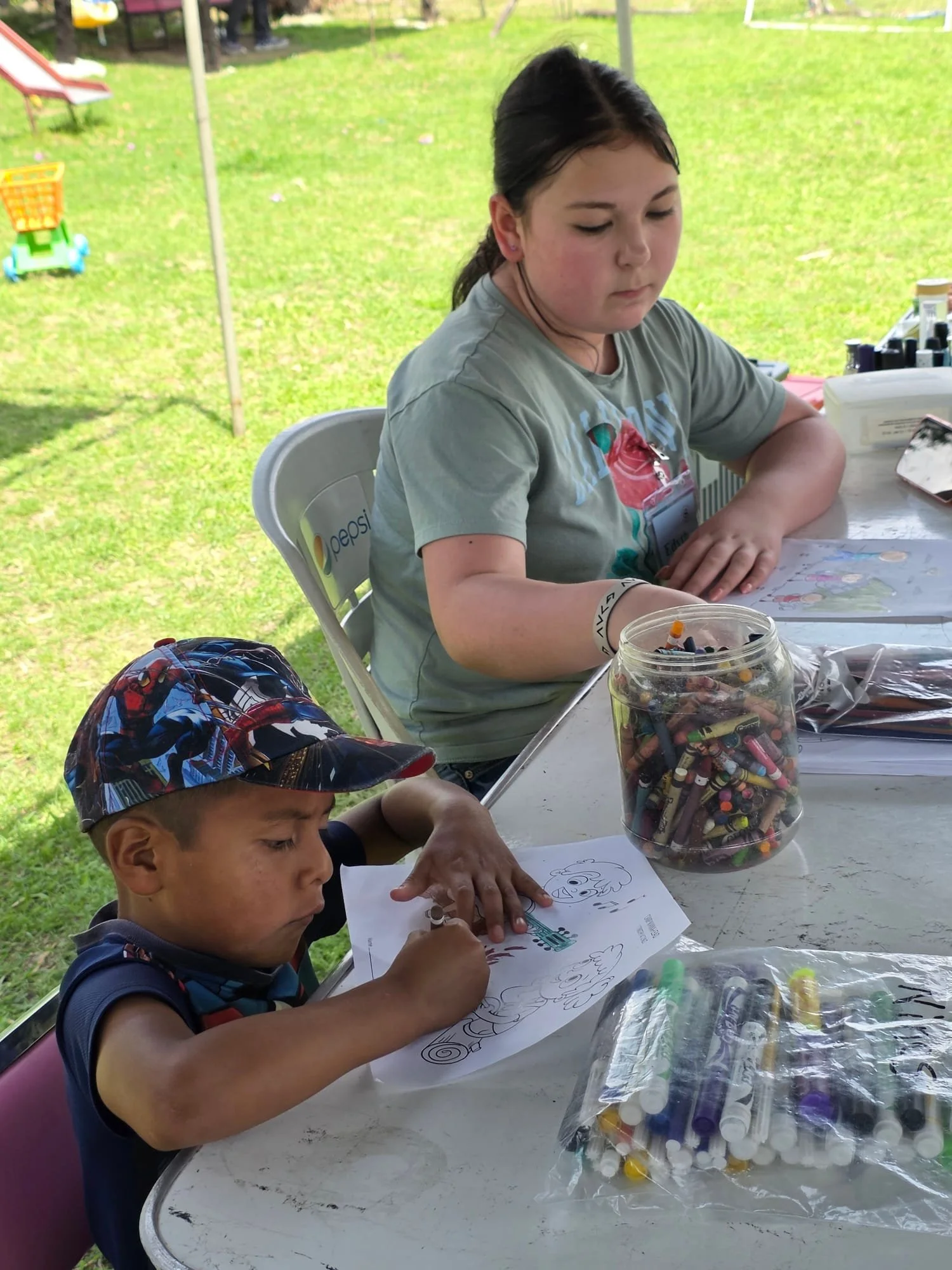 Children participating in a coloring activity during an Operation Serve International children's outreach.