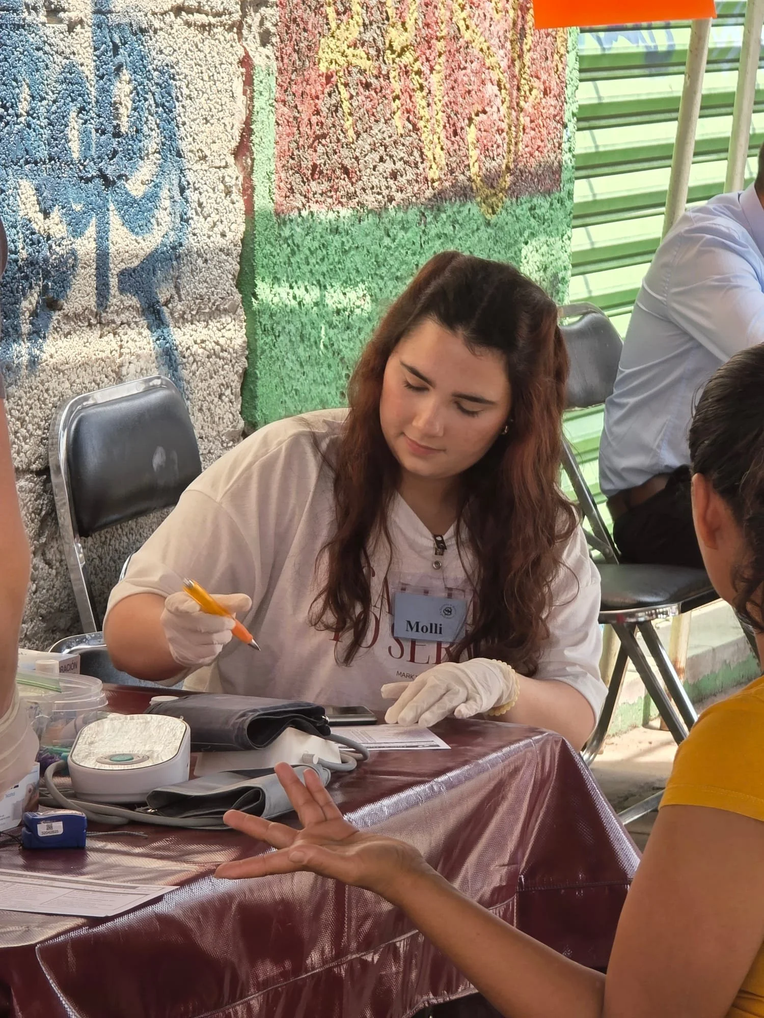 OSI volunteer, Molli completing paperwork for a patient