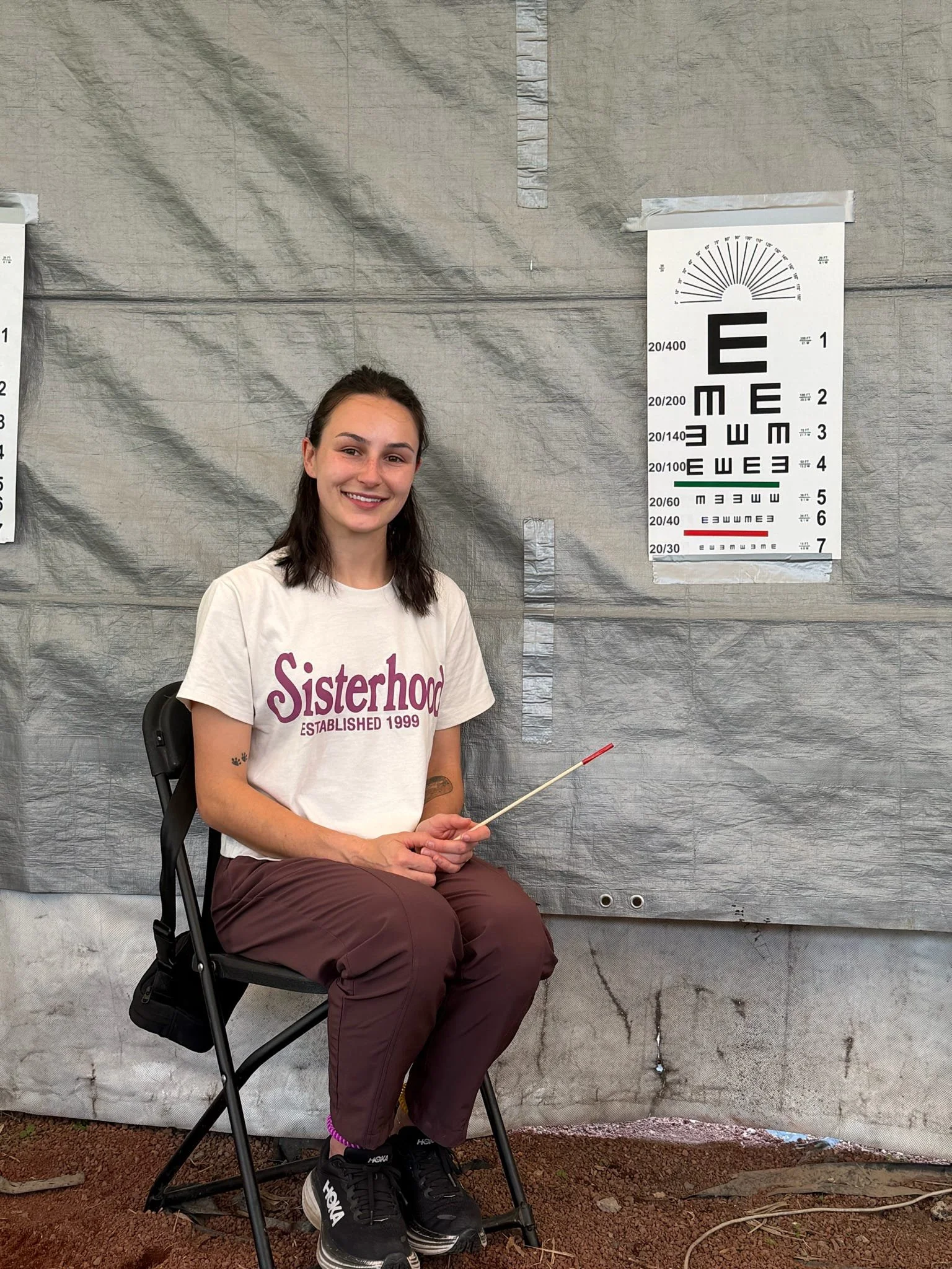 Volunteer preparing to perform a vision screening during an Operation Serve International medical clinic.