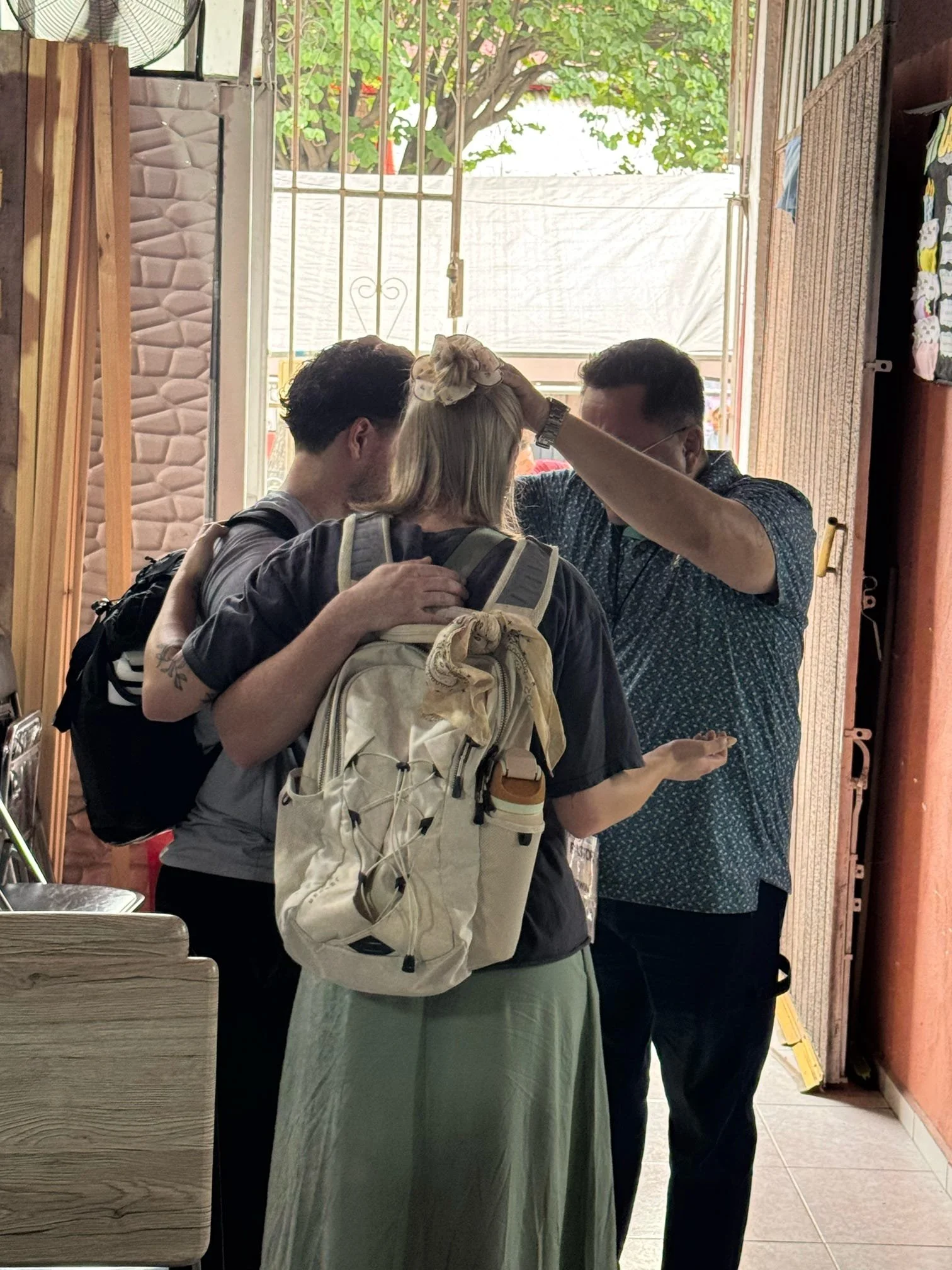 Church leader praying over volunteers before they begin serving the local community.