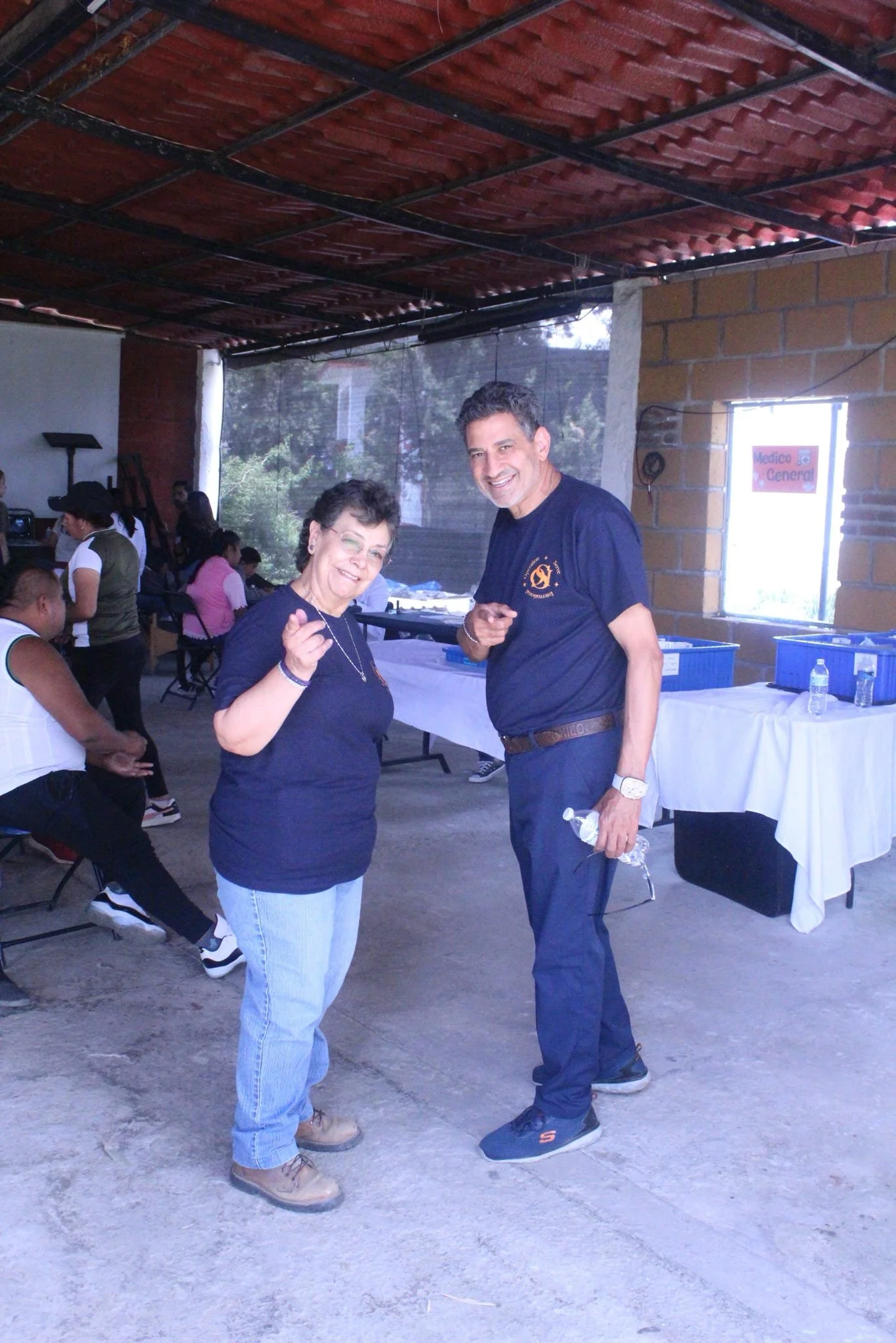 Operation Serve International leaders welcoming volunteers during a medical mission outreach.