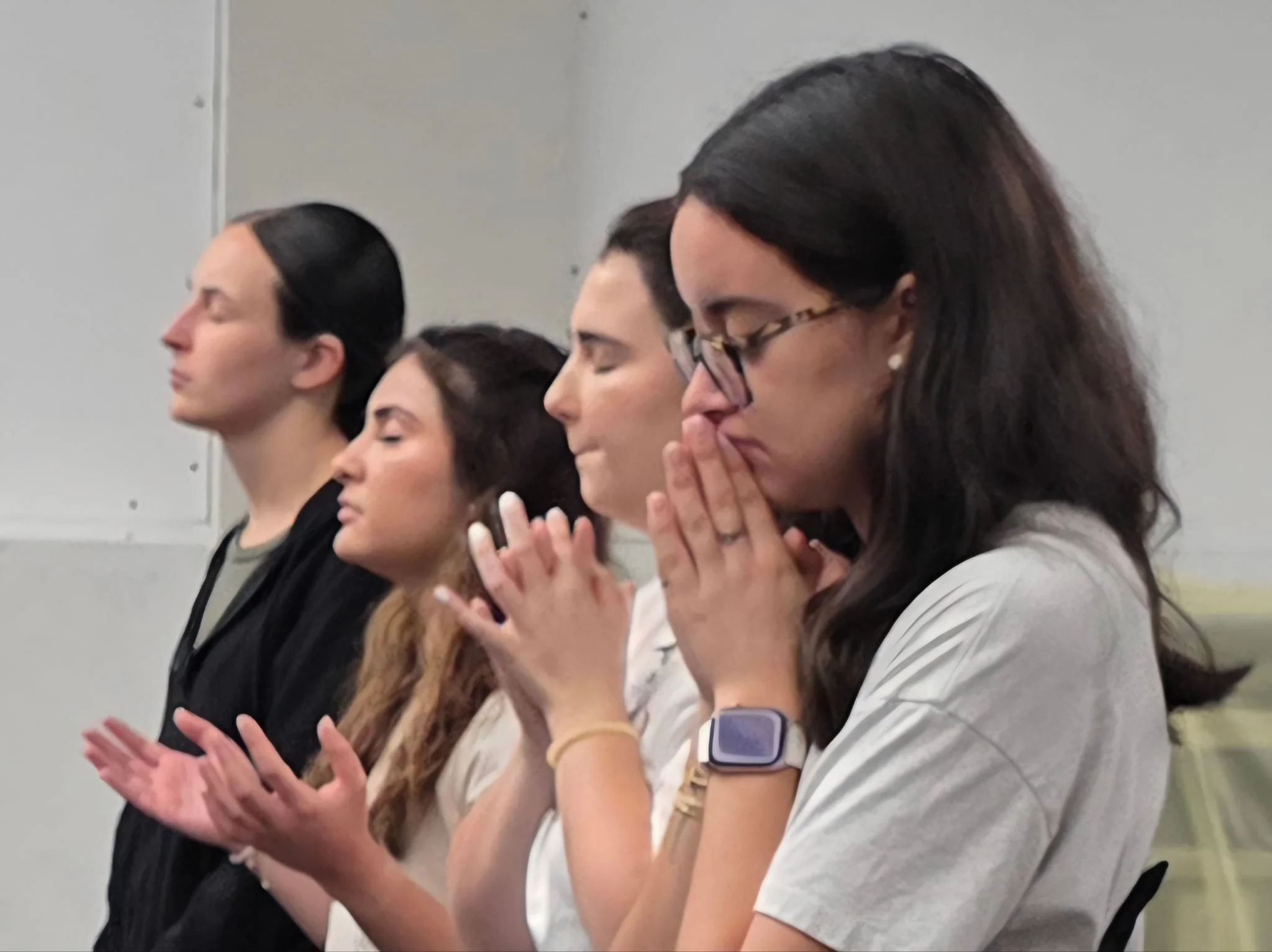 Volunteers worshipping in morning devotions before opening the outreach