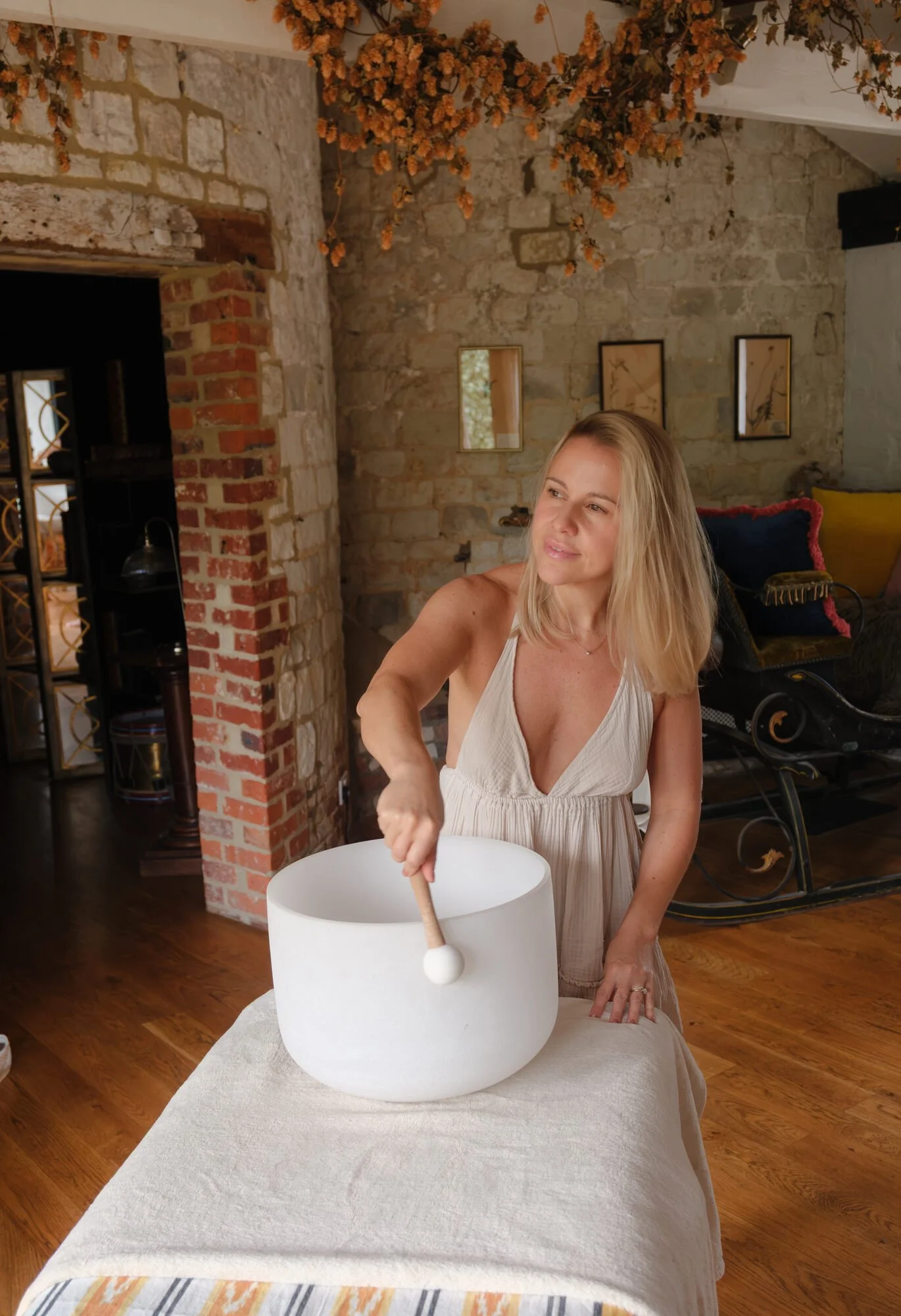 Jessica playing a crystal singing bowl during a sound healing session