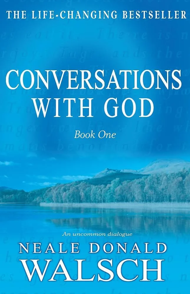 Book cover for 'Conversations with God, Book One' by Neale Donald Walsch, featuring a serene lake and mountain scene in blue tones.