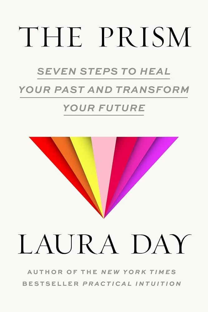 Book cover titled "The Prism" by Laura Day, featuring a multicolored prism graphic and subtitle "Seven Steps to Heal Your Past and Transform Your Future."