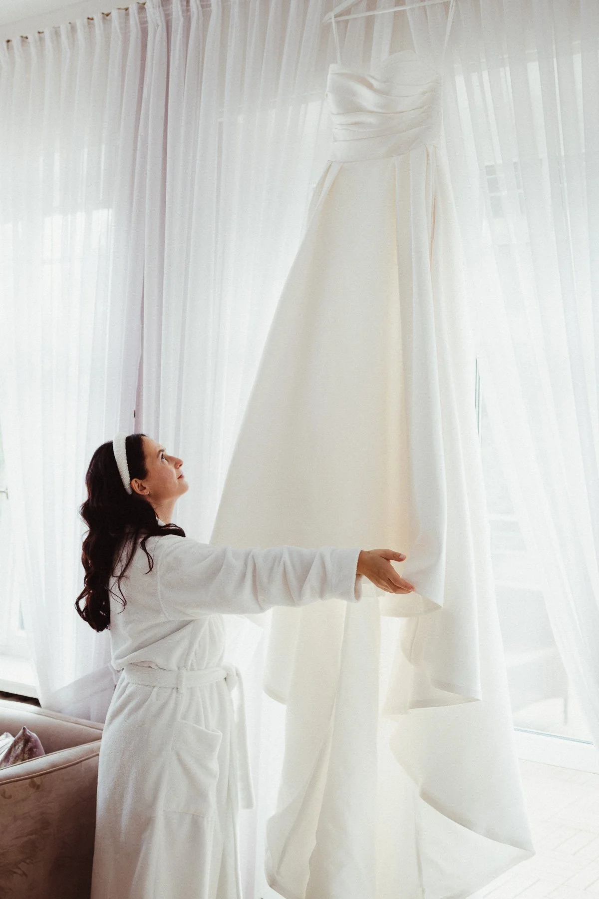 Braut betrachtet ihr Brautkleid