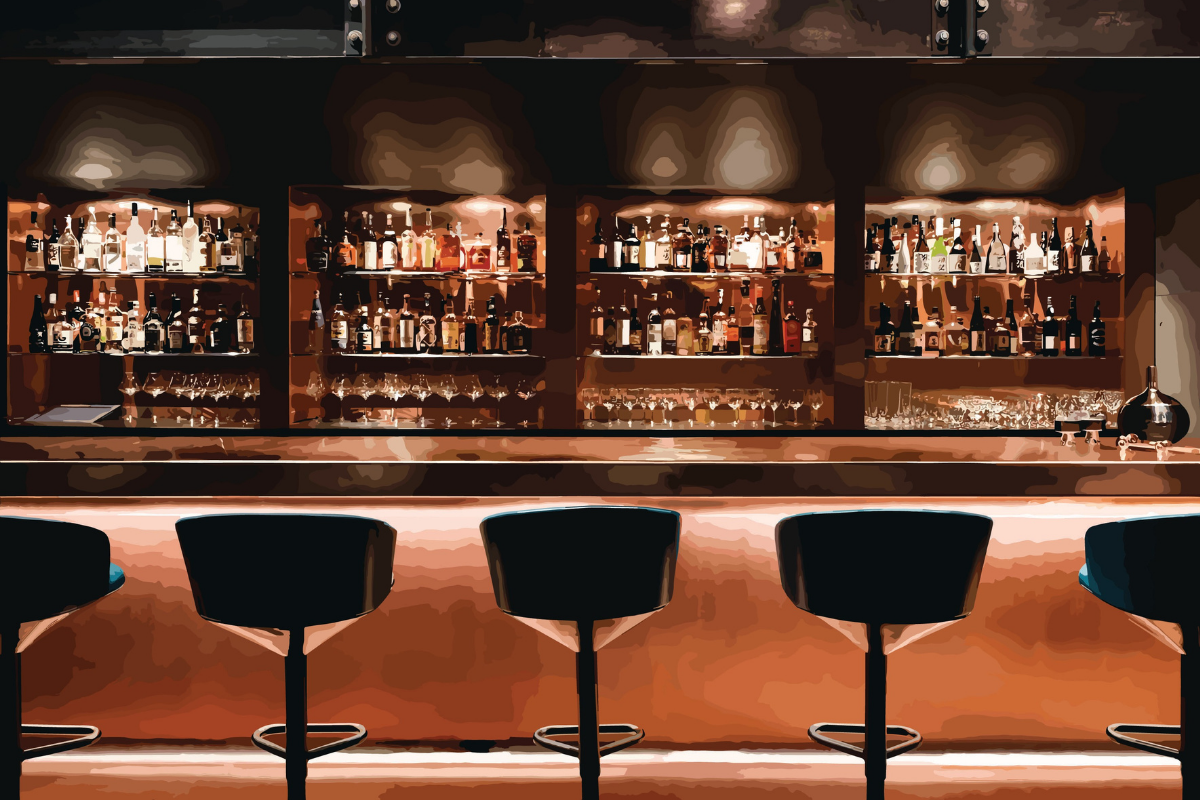 A dimly lit bar with three shelves of various liquor bottles and glasses, a bar counter with four black barstools, and a dark, sleek decor.