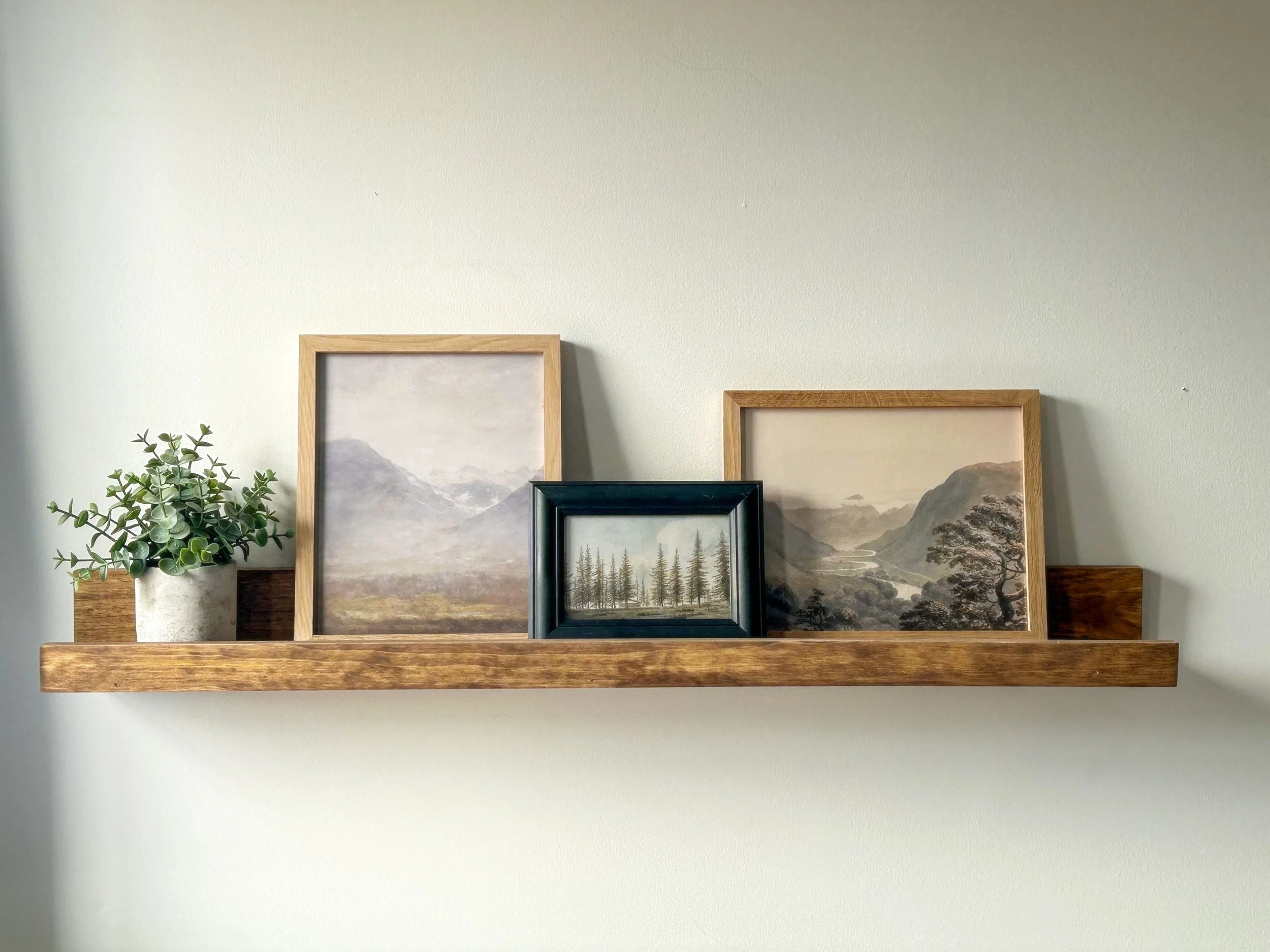 Handmade wood picture ledge for displaying framed photos, artwork and seasonal decor.