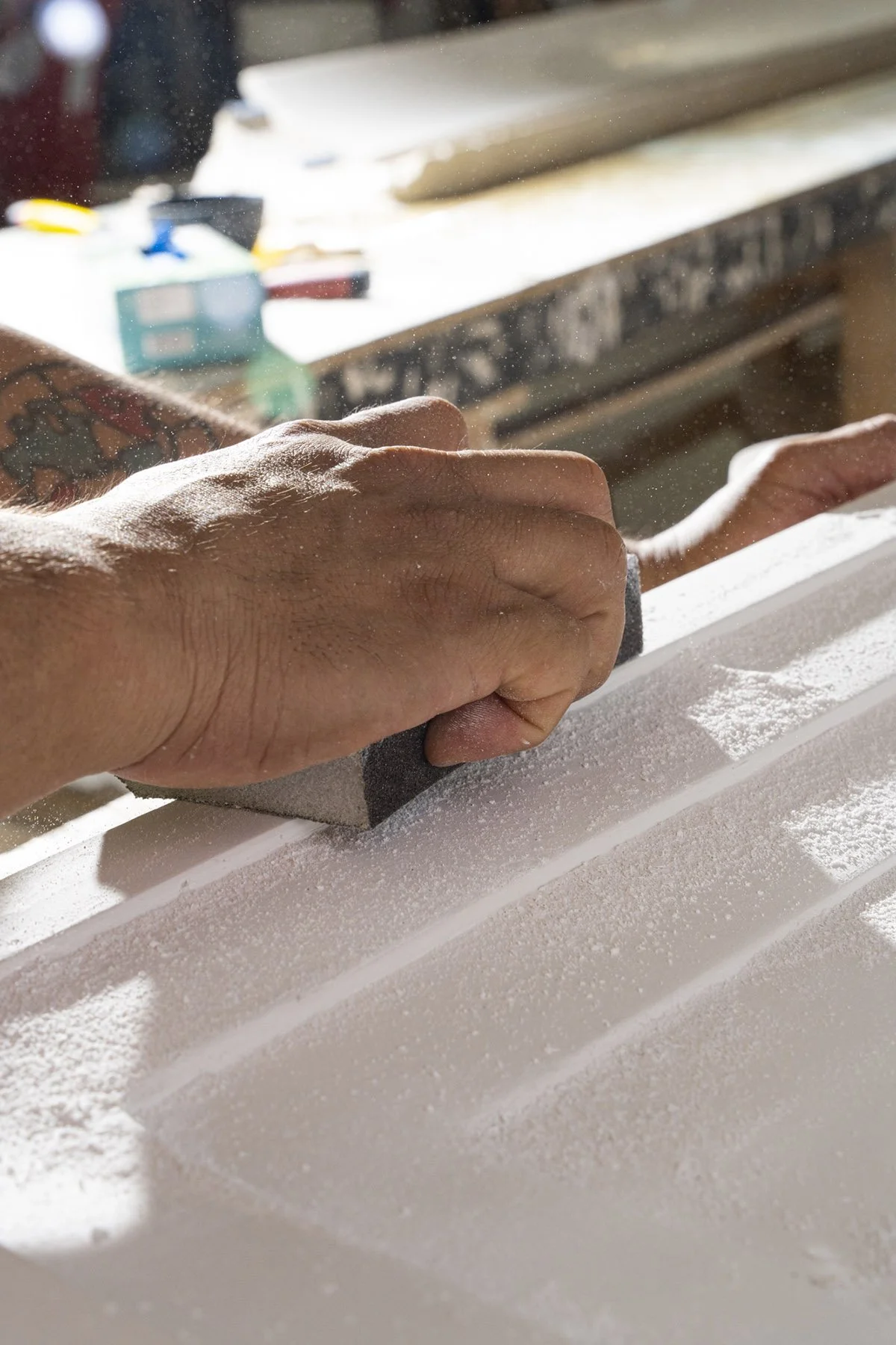 Photography of an artisan sanding plaster documenting the historic renovation of the Waldorf Astoria New York