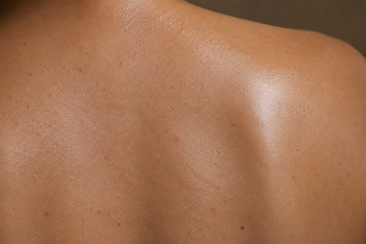 Close-up of smooth natural back skin representing professional back waxing and body hair removal.