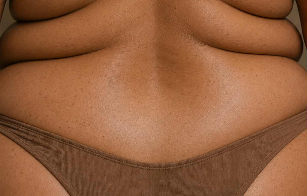Close-up of natural lower back back skin and visible skin texture representing inclusive professional brazilian waxing services.