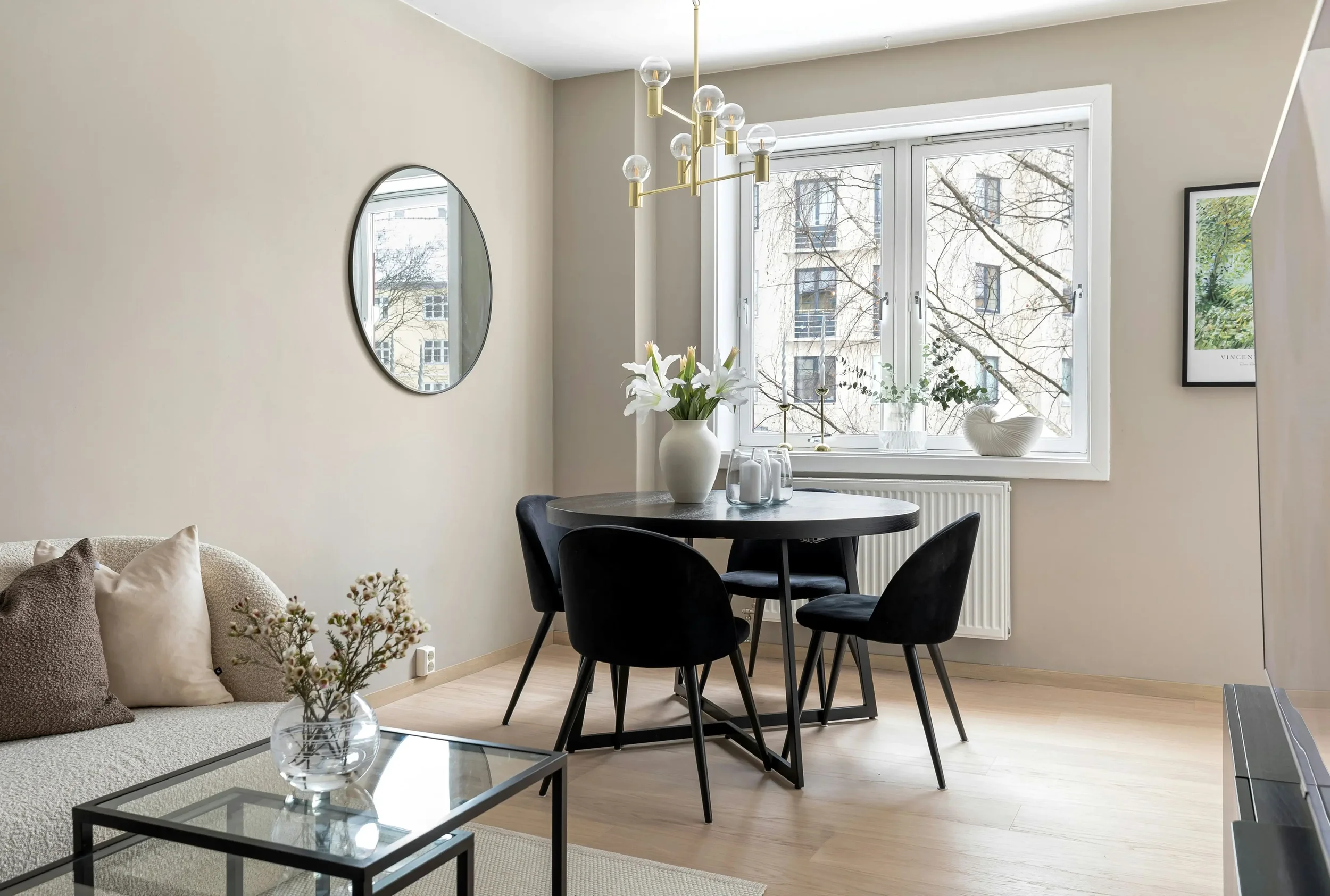 Neutral online interior design by Design my Space featuring a soft beige dining room with black chairs, modern chandelier and warm natural light.